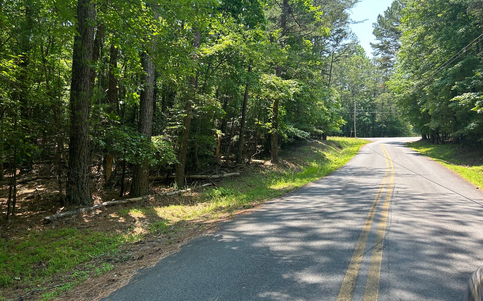 Hard to find, nice gentle laying, unrestricted lot at the corner of 2 paved county roads. All utilities available except sewer.