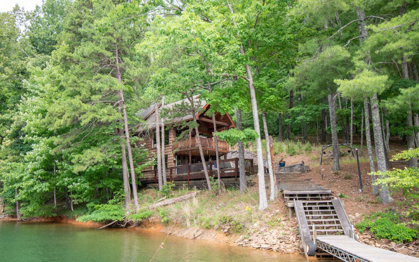 First Time on the Market!!! Come enjoy lake living at its finest. This cabin sits within a stones throw of Lake Blue Ridge. Located 1/2 mile from the entrance of Necowa Cove. Located near hiking and biking trails, Toccoa River, Blue Ridge Marina, and only 15 minutes from Downtown Blue Ridge. It's also located at the end of the road allowing privacy and no thru traffic. This property has everything you could wish for. Bring your clothes and toothbrush and relax on the lake. This cabin would make a great property for a full time residence, vacation home, or a short term rental. Owners currently rents this property on Airbnb.