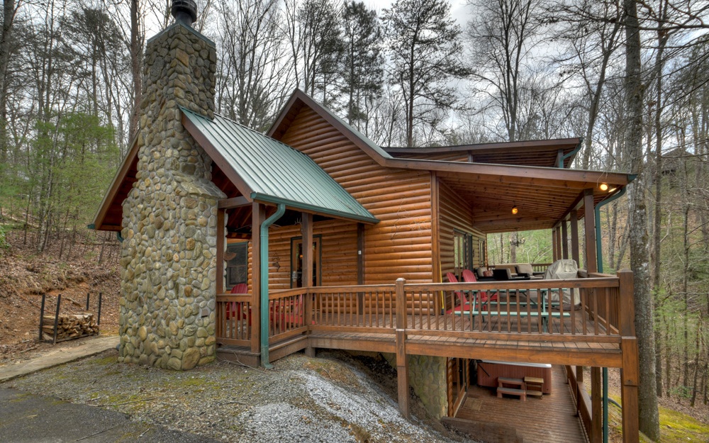 Captivating & Comfortable off the ASKA CORRIDOR within Walking distance of the Toccoa River.....Why Wait to discover this SUCCESSFUL Rental "Wilderness Way" in White Tail Ridge. D-Log Sided w/Exterior Fireplace "Party Porch" LEVEL Entry (Stone Pathway, Paved Access & Driveway). Recently Stained (9/2021) & New Hot Water Heater. Corner "River Slick" Fireplace in Great Rm w/Open Gable Glass. Large Dining Area,"Stone" Counterbar (Thick Wood Slab) in Spacious Kitchen. Hardwood & Tile Bath Floors. Main Level Bdrm (French Doors to Porch) & Very Spacious Full Bath. Upper Level Loft/Office plus Master Suite w/French Doors to Private Covered Porch (Walk-in Closet). Finished Terrace Level Bonus Rm w/"Built-In Seating, Pool Table & Wet Bar ("Stone"Countertop w/Live Edge,Refrigerator & Sink). "Built-In" Bunk Rm Area, 3rd Bdrm Suite & Full Bath w/STONE FLOOR, Jetted Tub w/"Rock" Surround & 2 Entries). "Maintained" Hot Tub on Porch. Round Log Railings, 10" Covered Porches 3 Levels on the View. Beautifully Furnished w/Log & Leather & Custom Blinds. Private Community only 7 Cabins.
