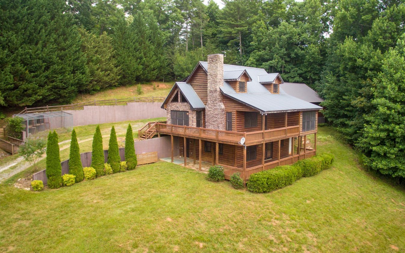 This magnificent home is located between Blairsville & Blue Ridge and is a must see. Nestled on approx. 2.5 acres provides privacy while being a short drive to enjoy shopping, dining, experience the outdoor activities of kayaking, rafting, etc,, scenic train rides and much much more. Enjoy the large yard filled with flowering shrubs & mature trees and plenty of space for a garden spot all with the mountains as your backdrop. Decks are located on both the upper & lower levels - plenty of room for having that BBQ, enjoying late evenings with family & friends, or relaxing after a busy day. An additional plus is the single car garage and a 40' x 30' building that could hold up to 4 vehicles, or ATVs, motorcycles, a fantastic workshop, provides lots of storage capacity. A metal outbuilding with poured floor & foundation is located on the east corner of the lot.