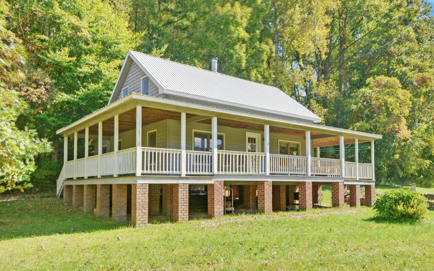 Riverfront Home! This charming home on 4.3 acres is surrounded by a lovely meadow that leads to the TOCCOA RIVER, frontage that curves around on 2 sides of the property. This wide river is easy to paddle on and is much wider than any other water source in the area. The home was custom built by the owner with all the fine touches of handmade cabinetry, lovely wood walls and furniture and floors. This is truly a delightful homey space that is tucked away yet close to the small community of Suches and the neighboring mountain communities. Dahlonega, Blue Ridge, and Blairsville are close. Hiking and camping at Vogel State Park and Woody Gap at the Appalachian Trail are just minutes away. This is an estate sale of a family home that has been well loved and thoughtfully built. There is a separate septic system for the laundry equipment. Built high up to prevent flooding but this property has never flooded since it was built in 1994. See the pictures of the recent hay bales cut from the meadow. The owner was a master carpenter, and every bit of this home shows his beautiful, careful work. You won’t regret looking at this home!