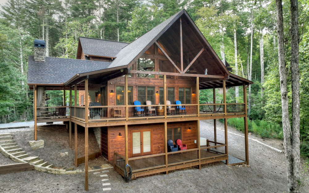 Prime Location in the ASKA adventure area sits this gorgeous glass chalet. This cabin offers year-round mountain views and is close to Stanley Creek and the Toccoa River. Surrounded by hundreds of acres of USFS making your outdoor activities unlimited. This lot is over 2 usable acres and includes a fire-pit area to enjoy the views. A separate matching, permanent shed for storage and a Cummings whole house generator. There is also a HUGE party porch with an outdoor fireplace. The main level offers a Master Suite with laundry and guest bath. Great room with the wall of glass taking in the stunning views. The upstairs offers another suite and a sleeping loft/office multi-use. The terrace offers another entertainment area with a full wet bar, additional bedroom and fireplace. This cabin is pristine and built by one of the most reputable builders in the area, Brandon Mathis. This place can be used for rental, weekend getaway or for full time living.