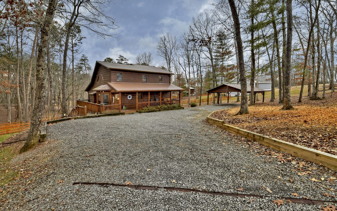 LOCATION, LOCATION, LOCATION! This well maintained 3/3 is only 8 miles to downtown Blue Ridge, 9 miles to McCaysville, and 21 miles to Murphy, NC. Situated on 2.28 acres. Wrap around front porch leads to screened-in back porch. Both connect to the spacious main level with great room, kitchen & island, pantry, dining area, laundry room, bedroom and bath. Upper level has separate bedroom and bath plus large loft area. Terrace level has separate bedroom and bath plus bonus room with wet bar with counter, wall cabinets and place for mini bar and mini fridge. Terrace level has concrete patio perfect for the hot tub. 2-Car pole barn carport. Plenty of additional parking in driveway. Large separate storage shed.