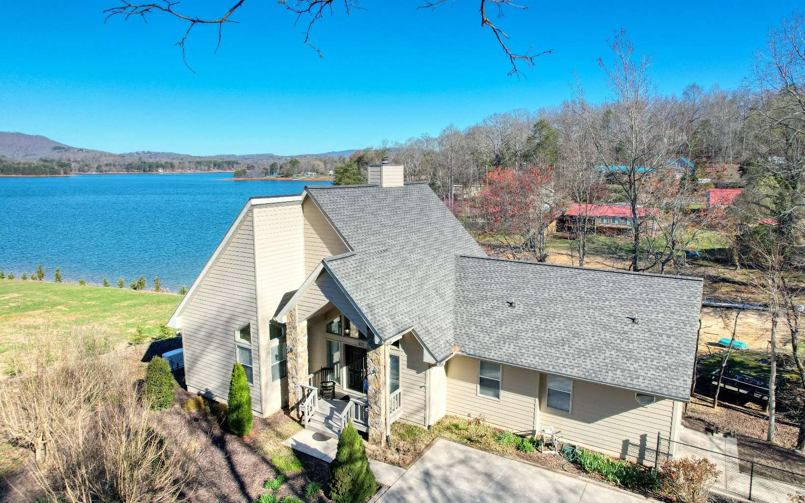Well Maintained Custom Built Lake Front Furnished Home Located in Hiawassee at Chatuge Shores. Offers Year Round Lake and Mountain Views, Permitted Dock in Place, Large Circular Concrete Driveway with Additional Parking Areas, HOME GENERATOR. Oversized Two Car Garage, Covered Screened Porch, Open Decks. Interior offers an Open Floor Plan, High Ceilings and a Chalet Style Design to Look Out to the Lake, Hardwood Floors, Granite Kitchen Countertops, All Appliances, Walk-In Pantry, Full Laundry Room, Open Floor Plan, Fireplace, Large Master Bedroom with Double Sinks, Jetted Tub and Separate Shower in the Master Bathroom, Walk-In Closets. Basement Has Two Bedrooms, Full Bath, Large Sitting Area, and Large 19x14 Storage Room. THIS IS MOVE-IN READY.