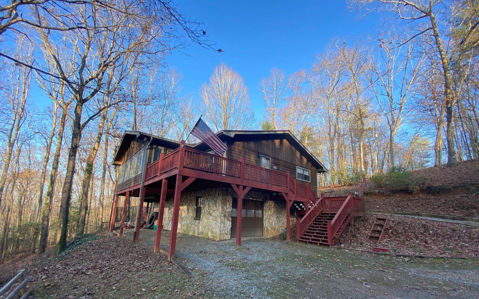 Affordable 3/3 in the Perfect Location. "Cabin Style" w/City Water, Less than 5 mi from Blue Ridge & under 2 mi to Fannin Hospital. Wood Lap Siding w/Board & Batten Gables, 4-Sided Rock Foundation, Metal Roof & Pull Under Garage/Workshop. Updated Wood Engineered Floors, Newer HVAC (2018) & Raised "Arch-top" Panel Interior Doors. Spacious Kitchen w/Tile Backsplash. Large Counter Bar opens into Dining Area. Extended Sunroom & Bonus Rm w/Casement (Crank-out) Windows. ROCK ACCENT WALL in LR w/Wood-Burning Fireplace (Tall Stone "Sitting Hearth"). Master Suite w/Private Bath (Full Shower Enclosure & upgraded vanity). Guest Rm & Hall Bath (Upgraded Vanity & Shower Enclosure).Terrace Level features 3rd Bdrm/3rd Full Bath (Clawfoot tub) & Laundry Area (Woodstove). Seasonal Views of the Cohutta Wilderness. Large Back & Side Yard for Gardens, Pets etc. Driveways to Both Levels. Adjoining Lot Available. All Paved Access