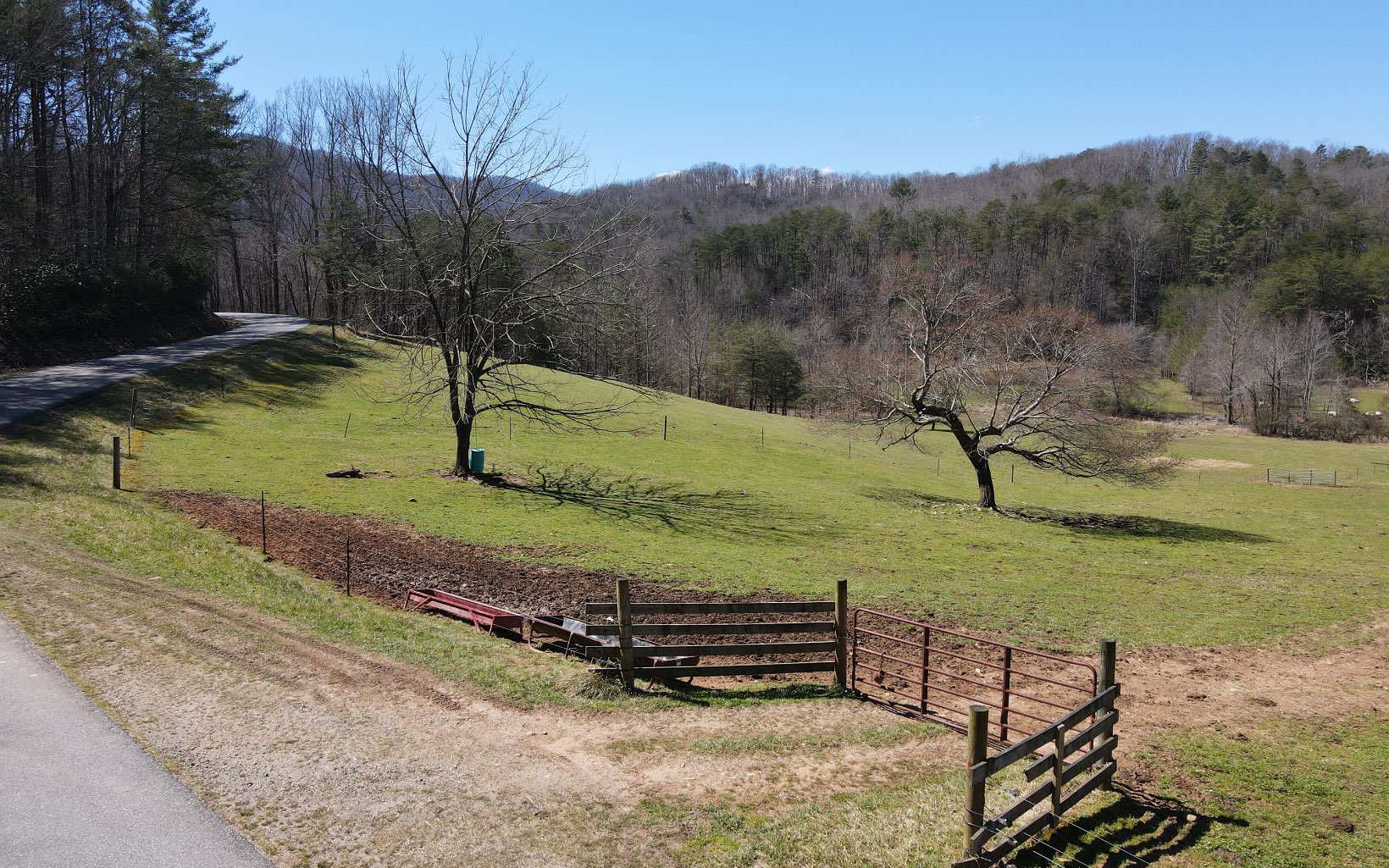 Possibilities are endless with this UNRESTRICTED 53.7 acre tract. An incredible INVESTMENT opportunity. Property is on both sides of the road. Apprx. 15 acres of pasture with creek frontage along one side and approx. 38 acres of wooded property with gentle terrain on the other. Bring your family and farm animals and enjoy your own oasis in the MOUNTAINS OF NORTH GEORGIA.