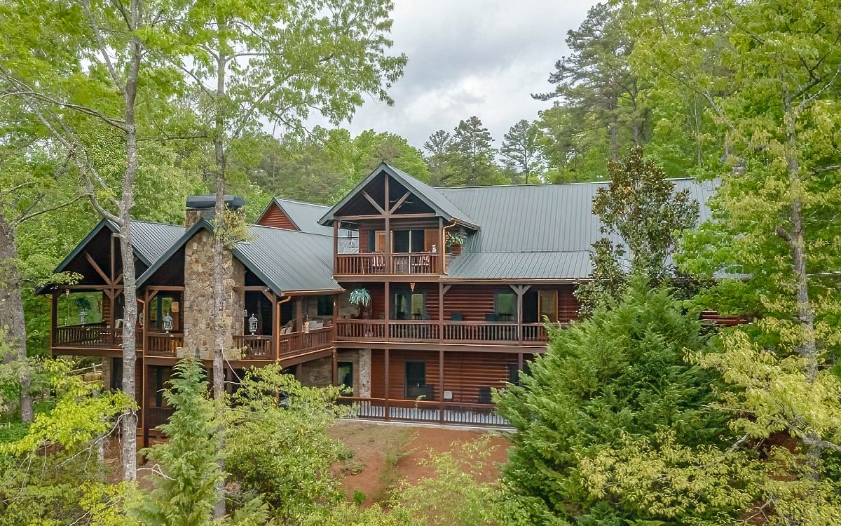 MOUNTAIN TOPS FAMILY ESTATE includes; 1 Lodge - 2 Guest Houses and 4 Garages on 6.93 acres with year-round mountain & pond views. THE LODGE - 5,236 sq ft 5 bedrooms, 4 full bathrooms & one-half bath, and four fireplaces. GUEST HOUSE #1 - features 900 sq ft, 2 bedrooms, 1 full bathroom, stacked stone gas fireplace & full-size kitchen. GUEST HOUSE #2 - 1,440 sq ft. features 2 bedrooms, 2 full bathrooms plus a loft area. Gas fireplace, full kitchen. The two-car oversized garage is below along with a view of the pond and audible fountain. GARAGE #2- the two-car oversized garage is below. GARAGE #3 - Collector’s Garage; 1,800 sq ft. with six plus car & 4 motorcycle capacity. Shower & sink with WOOD SHOP ABOVE, full AC and heat. GARAGE #4 - RV Garage - features 1,200 sq ft with its own pump out. **The extensive full detail of these properties is available in Documents.**