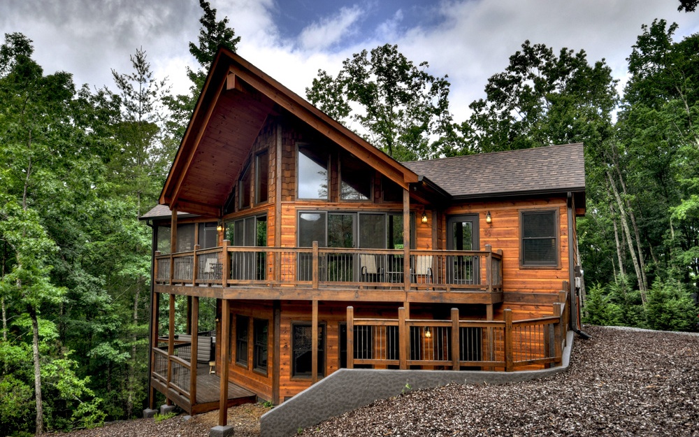 It's called Fawn Ridge for a reason! Conveniently located between Ellijay and Blue Ridge, this beautifully designed 3/3 1/2 mountain lodge has all the bells and whistles for your enjoyment. Easily accessible, long range mountain views await. Enjoy the view indoors and out compliments the party porch and the wall of glass bringing the outdoors in. Situated on 1.19 acres, this beauty offers many luxurious upgrades including an open flowing floorplan, soaring ceilings, stacked stone interior fireplaces, lots of glass for natural light, custom tile bathrooms, granite countertops, and so much more. Basement features a second master bedroom suite current used as a private owner’s suite that is not open to renters. Lots of space for parking or for play…..including a custom made horse shoe pit.