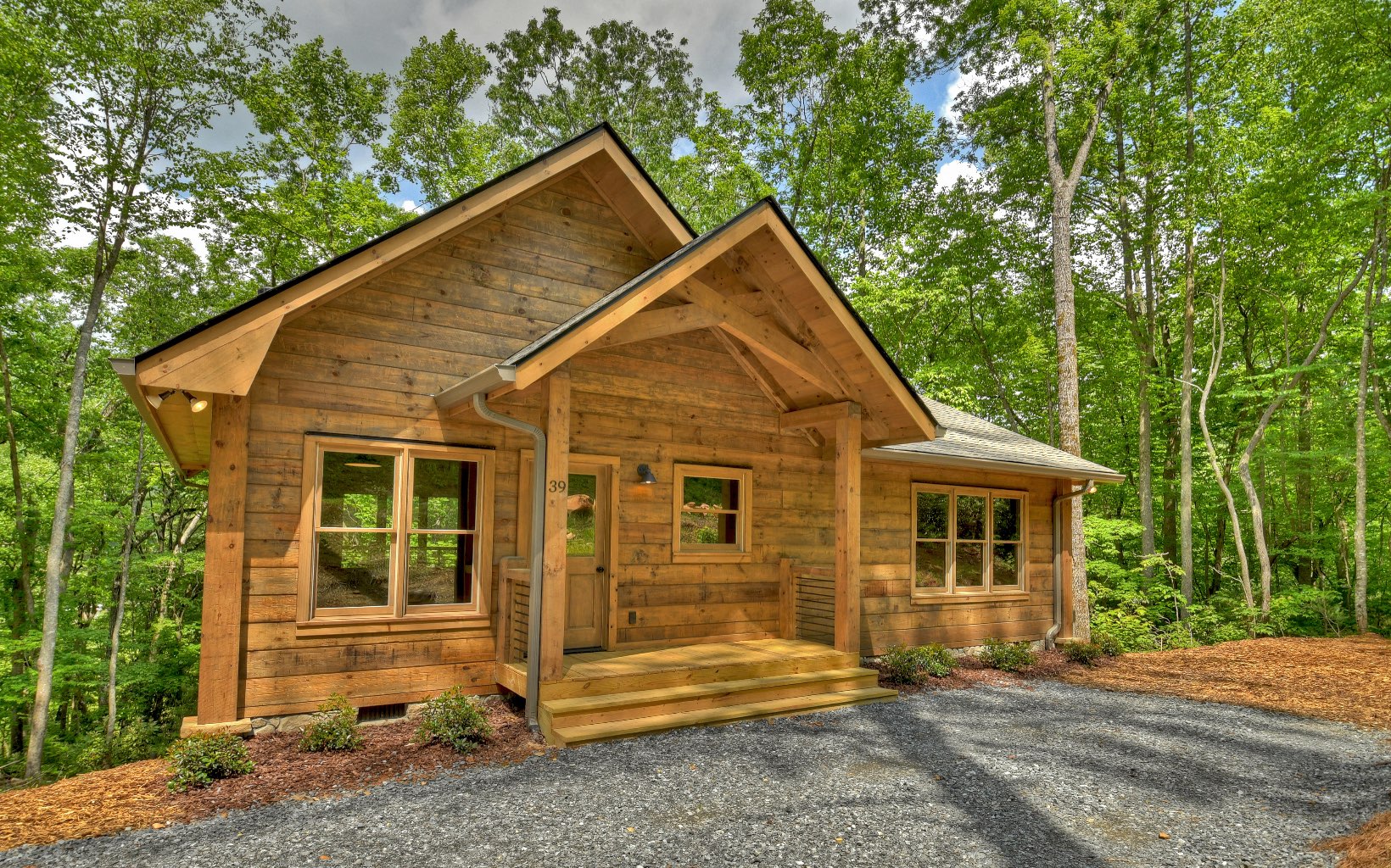 Mountain bikers dream. New real log cabin sitting on pristine creek features two bedrooms and two full baths. Open kitchen and greenroom with covered porch, wood floors throughout.