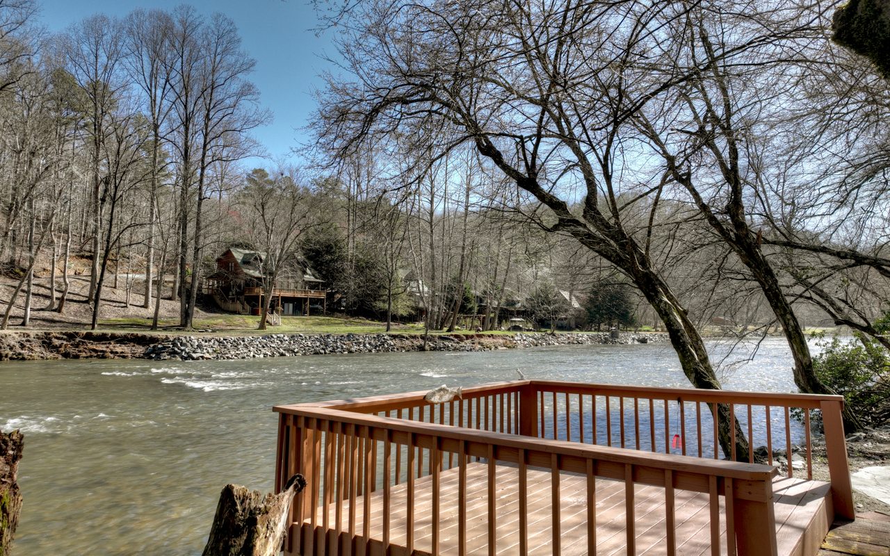 River frontage at its finest! On one of the widest parts of the Coosawattee river. Sit on your screened porch, deck or dock, and fire pit and listen to the river passing by. This is a split bedroom plan with the master on 1 side and 2 bedrooms on the other side. Open concept has an upgraded kitchen with Stainless Steel appliances, granite counters, and a large center island. The great room has a high vaulted ceiling and a gas fireplace. Master bathroom with separate tub and shower. There is a 2 car garage and a 600 sq ft flex space above the garage. It would be a great office or hobby room. There is actually a living area and bedroom. All that is needed is a bathroom. Down by the river is a firepit and dock at the river's edge. The cabin has over 2 acres that run up to Mooring. You could split the property and build a cabin up the hill.