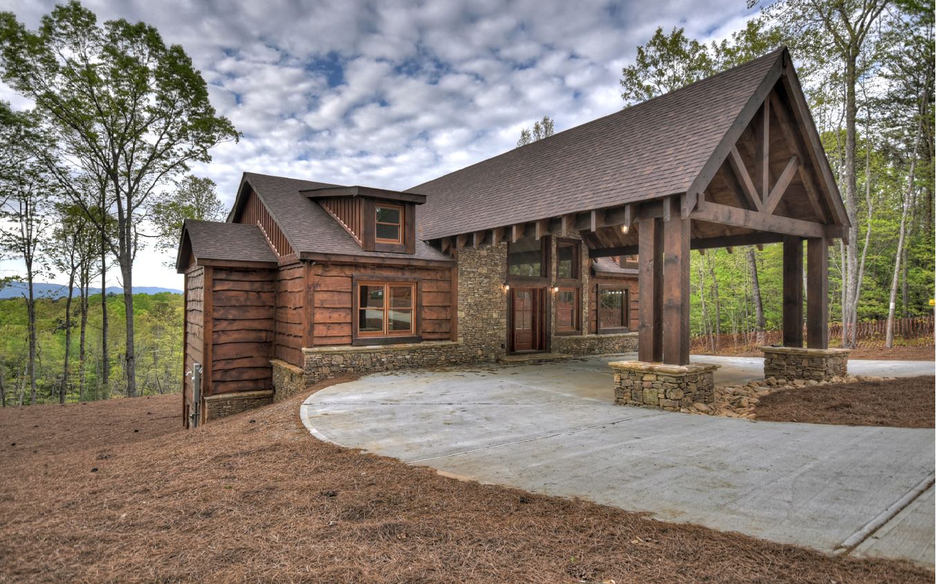 Mountain Retreat with Refined Rustic Flair & Long Range Mountain Views! 4BR/4BA w/plenty of space for the whole family in private location on 2 lots w/4.67 acres. Elegantly rustic finishes w/perfect mix of colors/textures. Main level w/open concept great room w/soaring cathedral ceilings/stone fireplace overlooking oversized party porch w/exterior fireplace, chefs kitchen w/massive pantry/SS appliances, ample dining space, master suite w/walk in closet/custom tile rock shower/copper soaking tub, guest BR/BA. Lower level offers spacious game room/den, large wet bar, 3nd fireplace, 2 guest BRs/BA, concrete patio. Concrete driveway/parking & porte co·chère entrance. Coveted location in high end community w/fiber internet service, paved roads, & convenient location within minutes of Blue Ridge & McCaysville, hiking/mountain biking, Toccoa River & Lake Blue Ridge all nearby. Gentle usable terrain.