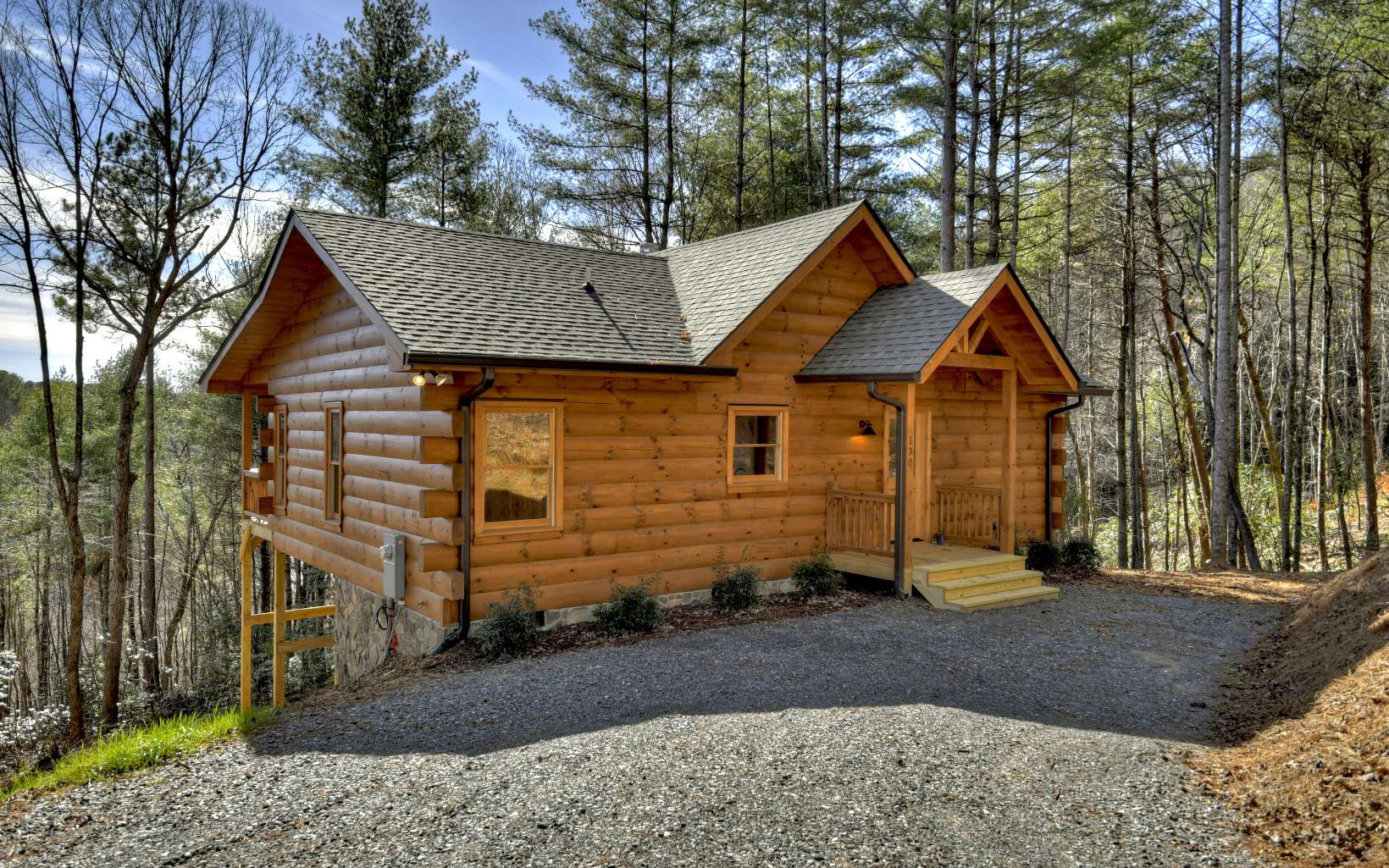 2x2x2: 2 bedrooms, 2 bathrooms, and "2" cute! Whether you’re considering part or full-time living, this majestic charmer allows you to escape the cares of the world. You'll delight in taking the scenic route with mesmerizing views of farmlands, mountain, ponds, & creeks, and upon arrival, you’ll be greeted by a lovely ridgeline view of your own! This location offers easy all paved access to everything you desire in North Georgia, as it is conveniently situated between Ellijay and Blue Ridge. Other highlights of this warm & inviting haven include: open floorplan with one level living, soaring ceilings emphasized by natural light & exposed beams, floor-to-ceiling stacked stone fireplace, hardwoods & rustic accents throughout, easy to maintain landscaping, and a spacious lot for room to roam complete with Lake Whitepath frontage. Are you ready to make those mountain memories?