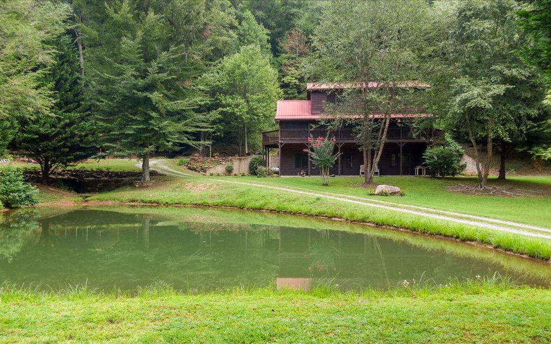 ONE OF A KIND SETTING AND FIRST TIME ON THE MARKET!!!! Check out this beautiful 3BD/3BA cabin on 10.58 acres on Ross Creek and overlooking a private stocked pond listening to the sounds of the bubbling creek and nature. You will fall in love with this beautiful setting!!!! End of the road location with complete privacy: This unique property has so much character!!! This home boasts 3BD/3BA soaring cathedral ceiling, stacked stone gas fireplace, well appointed kitchen with granite countertops and stainless steel appliances, master on main, large master bath, laundry on main, two bedrooms and full bath upstairs. Terrace level has a finished full bath and could easily finished for a 4th bedroom. There are endless possibilities with this beautiful property and so much space. This cabin is made for the laidback luxury mountain lifestyle! You will want to come to the mountains for this!!!!