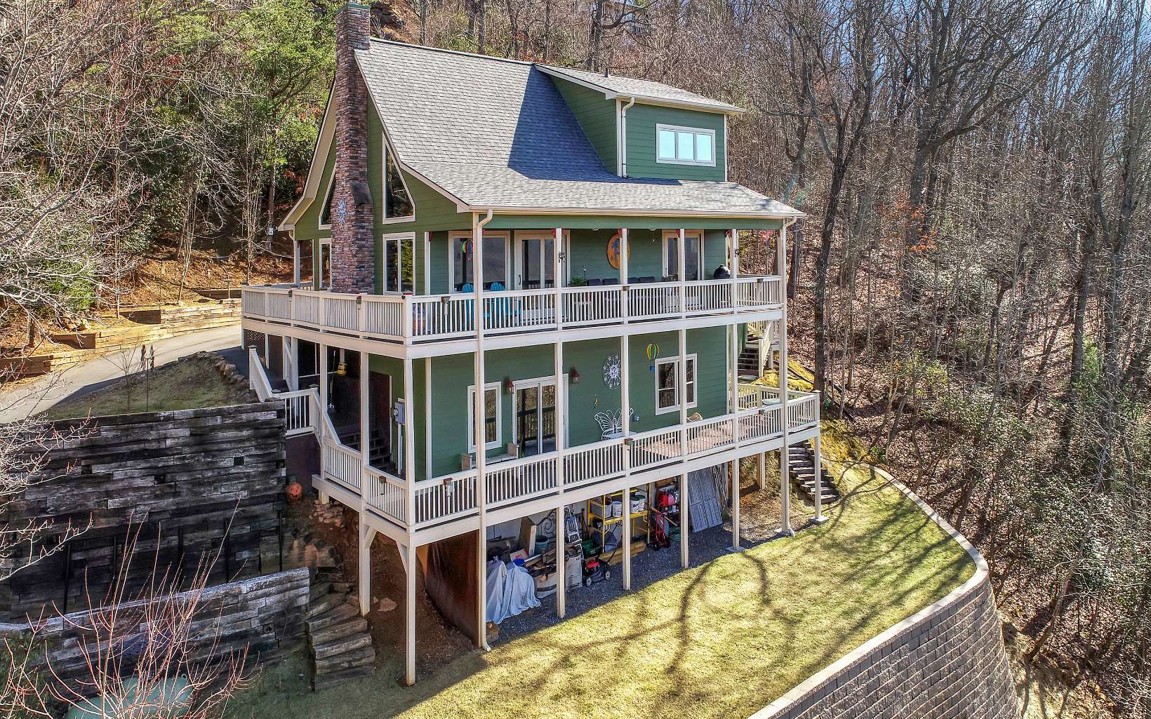 Big mountain and lake views in the heart of downtown Hiawassee. 3bdr/3bth/3story, completely renovated home. Pella windows, new smart appliances, Trane AC, new water heater, newly built 20 foot retaining wall with 20 feet of usable yard space. Electric, gated driveway, 240amp RV Hookup and many more upgrades! Being sold with two adjacent lots, all together equaling 1.15 acres that offer total privacy while still being in a neighborhood setting. Two minutes from groceries, restaurants and shopping. Five minutes from boat launch, kayak launch, and soon to be built boardwalk at Lloyd's Landing. Relax on your wrap around porch as you enjoy the everchanging scenery. Music on the Town Square, a front seat to the holiday fireworks shows, church bells and amazing sunsets can be enjoyed right from your deck. This home would make a great short-term rental, vacation home or full time residence. This location has the best of everything and is move in ready!