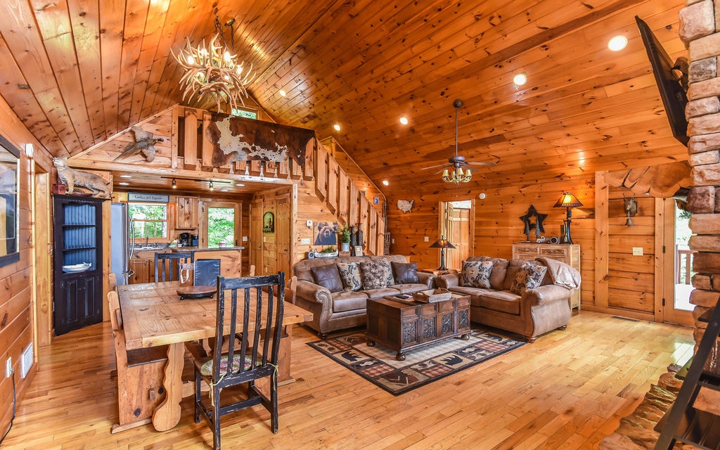 Enjoy year-round long range, layered mountain views from this beautiful home appropriately named "A Heaven on Earth". This hand-hewn log home features wrap-around porches. There is a beautiful floor to ceiling rock, gas fireplace in the great room flanked by large windows to enjoy the long-range view. Sleeping is no problem with two masters on the main level, a loft for extra sleeping or office, and the terrace level features two additional large bedrooms that share a full bathroom, den/game room with fireplace, pool table, foosball and air hockey too! NEW GRANITE COUNTERTOPS being installed in the KITCHEN & LVP being installed in the TERRACE LEVEL in AUGUST! Step outside and enjoy the hot tub or walk a few extra steps and roast marshmallows over the firepit. You're only 10 miles from downtown Blue Ridge and McCaysville, 12 miles from Lake Blue Ridge, 11 miles from Aska Rd and Copperhill, TN. Shopping, hiking, rafting, boating, fine dining, wineries and breweries are plentiful! Home is currently on a short-term rental program with excellent rental history. Furnishings are negotiable on a separate Bill of Sale.