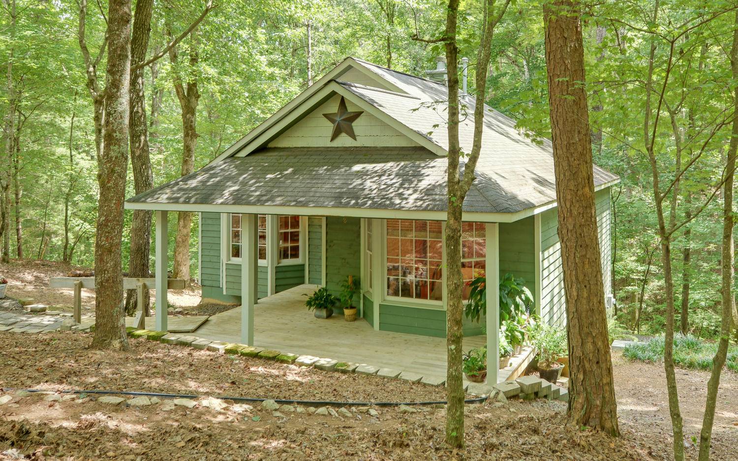 Enchanting Mountain Get-Away~ This FULLY FURNISHED 2/2 Cottage BLACKBERRY STREAM is a Dream to Mountain Lovers and River Lovers alike~ Just Moments to the Shoals on Clear Creek and Ellijay's WINE COUNTRY~ Currently an AIRBNB with a Great RENTAL HISTORY~ This Cabin on a Noisy Stream Offers a Charming Open Floor Plan- Main Level Offers 2 Bedrooms /1 Bath~ Eat In Kitchen/Dining Area and Living Room with Gas Log Fireplace plus Deck Overlooking the Stream! The Terrace Level Includes 2nd Full Bath/Partial Finished 3rd Bedroom/Office-Laundry Area and a Large Unfinished Space to make a Fantastic Entertainment or Family Room- So Many Great Possibilities! The Generous Lot Includes both sides of the Stream with a Lovely Fire Pit Area and So Much Peace and Tranquility ~ Loads of Parking and Just Minutes to Town.