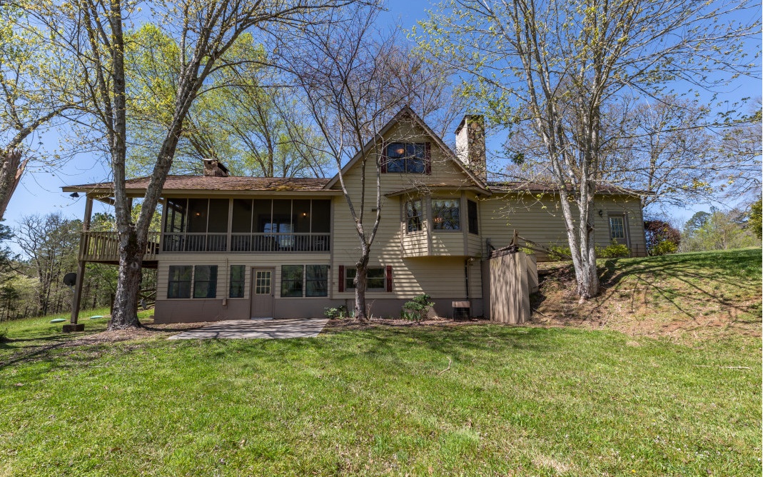 **Home is under contract and still accepting showings and offers.**Your relaxing mountain home awaits with a roomy 1859 sq ft of split-level living space and lots of natural light situated on a peaceful 23.77 acres of gentle land in the Trackrock area. The main-level LR features wood-paneled cathedral ceilings, exposed beams, a stone fireplace (wood-burning), and 2 double-paneled French doors that open onto a wraparound porch and screened deck with mountain views. Spacious eat-in kitchen with stone fireplace (wood-burning). Owner’s suite on main level, plus 2 bedrooms and 1 bath upstairs which features a skylight. Terrace-level 2nd laundry room, plumbed bathroom, plus loads of sunny, unfinished space with amazing potential and lots of windows. All-electric, central HVAC, private well, and 2-car garage. Includes a barn and a metal outbuilding, both with power. This very well-cared-for home is just waiting for its next family! Conservation covenant added 3/1/22.