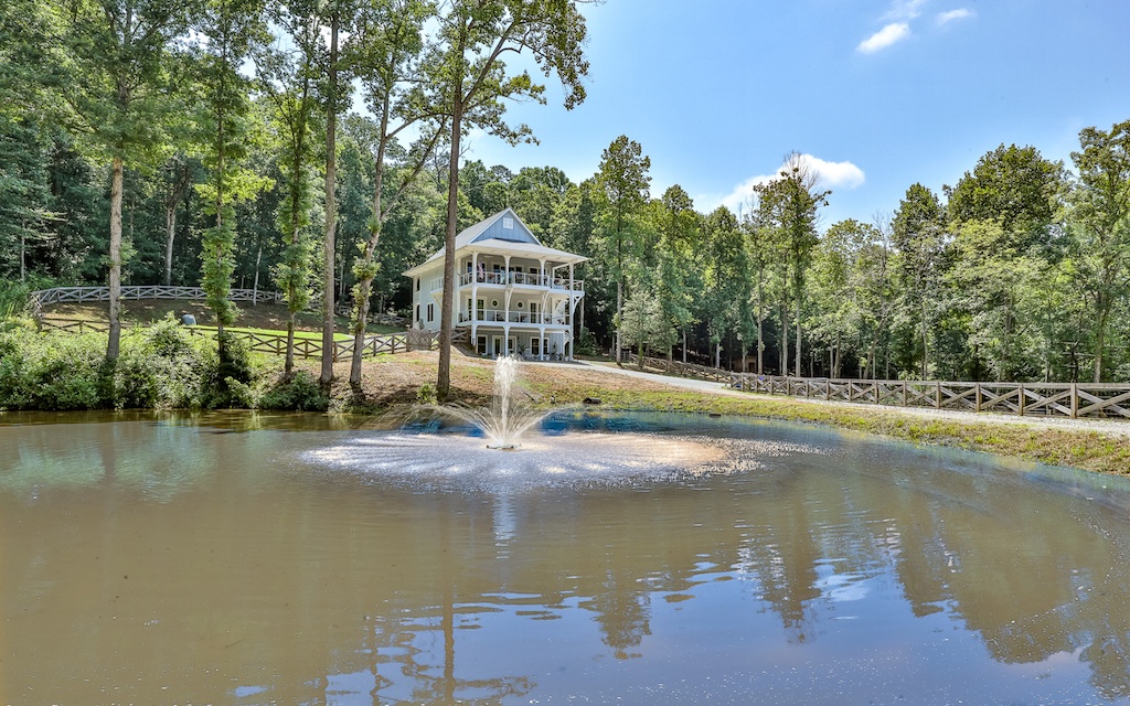 Torn between owning a beach house or a cabin in the mountains? Now you’ve found both! This one of a kind, turn-key 3 story 4 BR/4.5 BA “beach house” with an elevator sits on 18.27 private acres with no covenants, restrictions or HOA. Bring your animals; multiple fenced pastures & 2 barns. Lighted fountain in a stocked pond to fish off your private covered & lighted dock with sink. Lots of trails for horseback riding, ATVs and tons of creek frontage with ample room to build more homes! This immaculate home is loaded with upgrades and special features. Curava countertops, hurricane sliders, 5 camera system, whole house generator, commercial grade flooring, in-law suite, 2-car garage, remotes to control all outdoor lighting/fans. Too much to list here! Special Features list available – just ask. A must see!