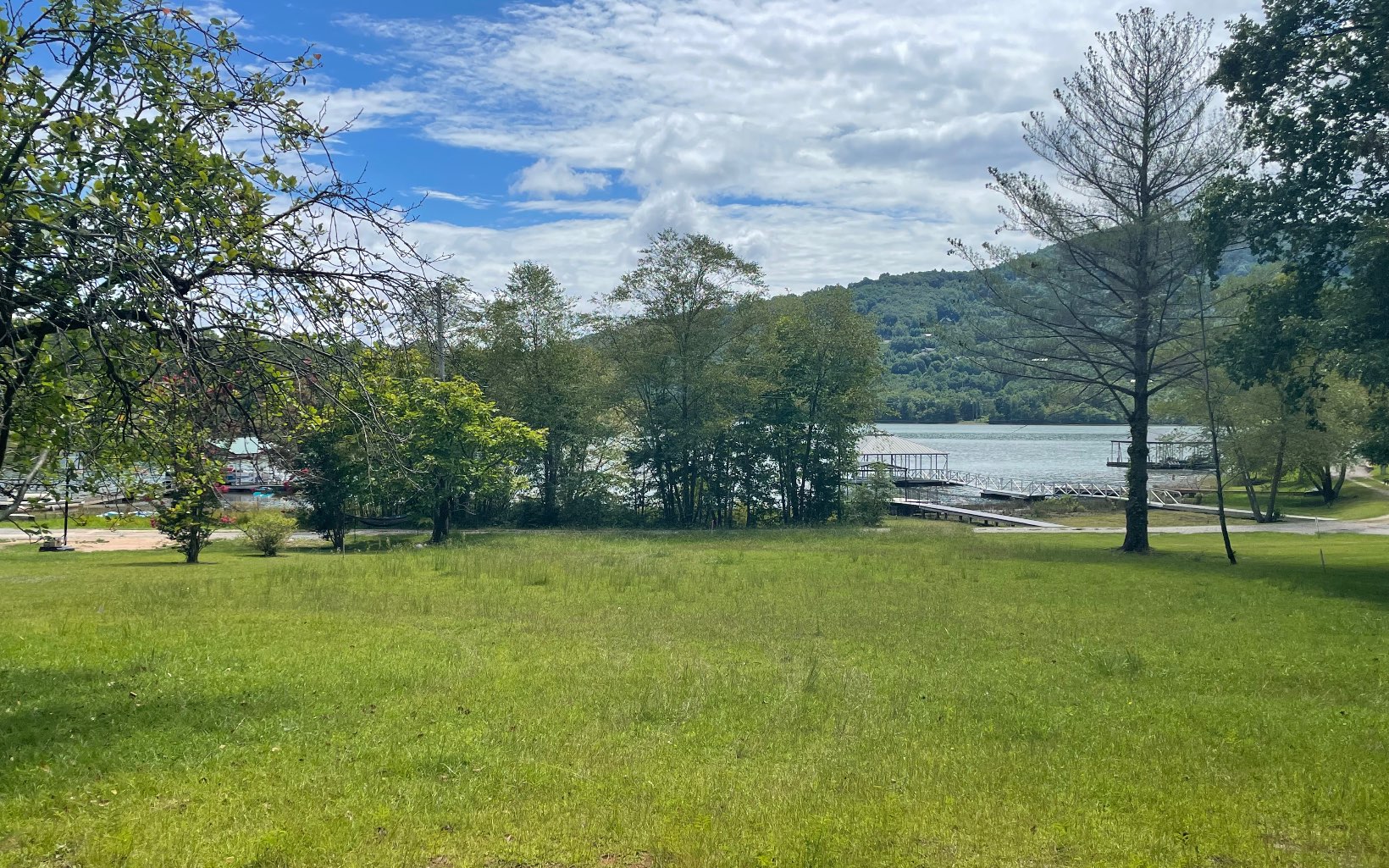 LOCATION LOCATION LOCATION!!! 0.56 acre gentle lot with year round views of gorgeous Lake Chatuge! Lot actually fronts the 1933' lake contour. Easy access, paved road. County water available but has private well in place. Septic is also in place. UNRESTRICTED -- bring your RV/camper/tiny home or build a barndominium! New survey just completed. Within walking distance to the USFS that connects to Lake Chatuge! Less than 1/4 mile to public boat ramp, marina and boat rentals! 10 mins to the quaint town of Hiawassee, Ga with restaurants, shopping, & medical facilities. The Appalachian Trail also goes through the county, and many other hiking trails and waterfalls!