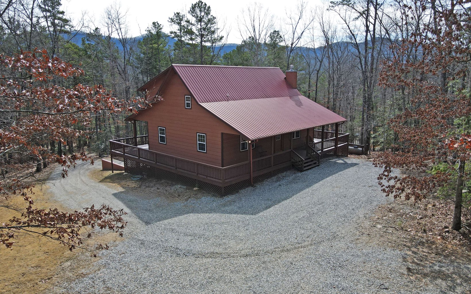 Cabin in the Woods with Private Setting! 2.95 Acres with Complete Wrap Around Deck to Enjoy the Seasonal Mtn Views! Rustic Inside & Out + Wood/Sheetrock Mix for a Pop of Color. Vaulted Tongue & Groove Wood Ceilings, Gorgeous Hardwood Floors, Rocked 'Vented' Fireplace Quality Wood Doors & Metal Roof. Kitchen with Granite Countertops, SS Appliances & Dining Area w/ Access to the Porch to Enjoy the Deer & Fresh Mtn Air! Main Floor Bed/Bath. Master Upstairs + Huge Loft for Office or Play Room? Baths Offer Granite & Tile Showers/Baths. SPACIOUS LIVING in this Mtn Cabin! Basement Offers another Bed/Bath + Bonus Craft-Room, Lots of Open Space for a Family/Game Room + Stubbed for a KITCHEN "In-Law Suite Potential"! Plenty of Room for your Family & Friends to Enjoy! Main Level & Basement Level Parking + Potential RV Parking? Private Well. Useable Wooded Property!