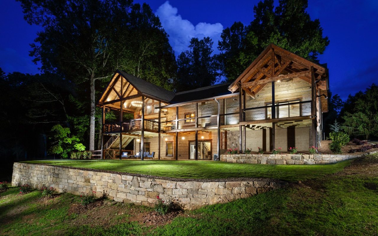This custom built 3200+ square foot Lomonaco Log home and 3360 square foot barndominium are located minutes from some of Ellijay's most popular vineyards and apple orchards. The 3.55 acres of unrestricted land features a private pond with a gazebo and putting green. The home's kitchen features an 8 foot island and stone backsplash. The vaulted ceiling in the great room showcases Aspen ceilings that are accented with large Engelmann Spruce beams. Throughout the home, you will see a variety of different wood species mixed with stone and other natural elements. The terrace level living area has 16 foot sliding doors that open to large covered porches. The terrace level also features a bedroom and bath, as well as a workout room that could easily be converted to a bedroom. The detached Barndominium is a one of a kind. Over 3,000 sq. ft. of heated and cooled space, including a full bathroom and full kitchen with Viking Appliances. It features a great Man Cave/ Entertaining area and office, complete with gas fireplace. Three large roll-up doors large enough for parking a full-size motor home! The grounds feature a pond with gazebo and fountain, as well as fire pit. Established grape vines allow you to possibly make your own wines. Additional adjacent 1.50 acre tract available.