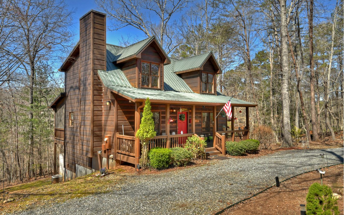 Relax and enjoy this fabulous rustic cabin featuring an open floor plan on main with gas log rock fireplace, Refrigerator, Stove (2022), Dishwasher (2019), microwave (2021), separate Dining area, W & D (stacked but full size-2020), BR, BA; Upstairs - Loft, BR with ensuite including garden tub; Terrace level - Full bsmt. with BR, BA, office, & workshop. Extras include exterior cameras, exterior lights (on dusk to dawn), shades on all windows, Large screened porch, exterior stained (2020), termite stations, outside shed, security system, generator, some furnishings/accessories remain. Septic permitted for 2BRs.