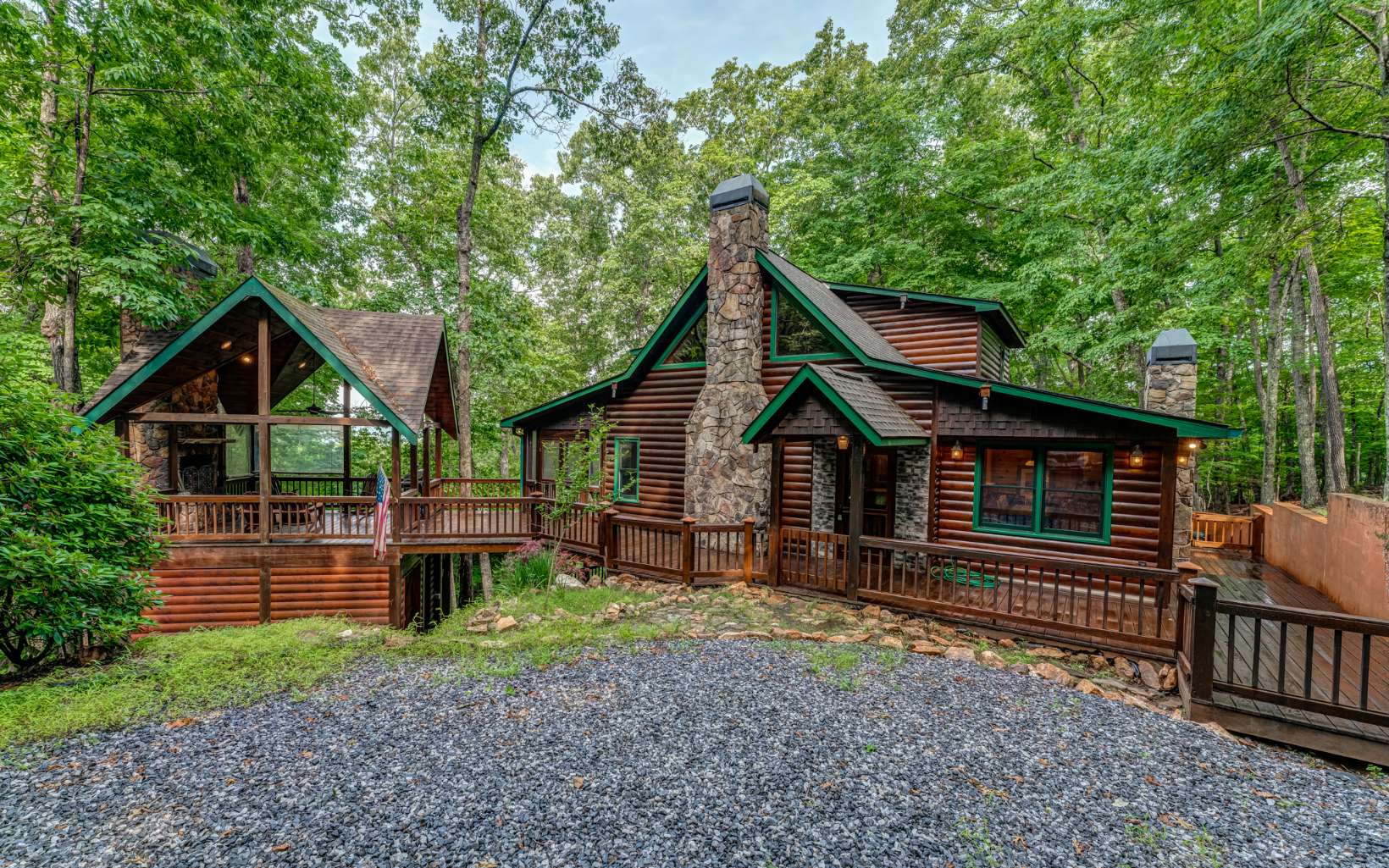 Look no further - your mountain paradise awaits! Solid cedar log siding is a sight to behold. Impeccably maintained, freshly stained and washed. This home is truly move-in ready like you’ve never seen. Expansive wraparound porch gives you a 360° view of the mountain wilderness all around. Detached outdoor fireplace is absolutely begging to be cuddled up next to. All-weather screened porch coverings make the decks enjoyable 365 days a year. Inside, you will find stunning tongue and groove cedar planks all throughout the home and solid hardwood floors flowing seamlessly throughout. Providing the luxurious cabin feel that you come to expect from the North Georgia mountains. Vaulted cathedral ceilings are absolutely spectacular. Large, spacious windows allow the natural light to beam through, so you can truly enjoy the outside coming in. Open floorplan main level, with updated kitchen overlooking the main living spaces. Complete with updated stone countertops, stainless steel appliances, subway tile, and so much more! This is truly a chef's dream kitchen. Expansive dining area seats as many people as you can invite! Gas fireplaces are located in nearly every room throughout. So you never miss out on a cool night by a cozy fire. Bathrooms have all been updated to the nines, including walk-in showers and floor to ceiling tile. Oversized master suite includes a private owner's closet, sizable en suite, sitting area with its own dedicated fireplace, and 180° storm windows to overloo