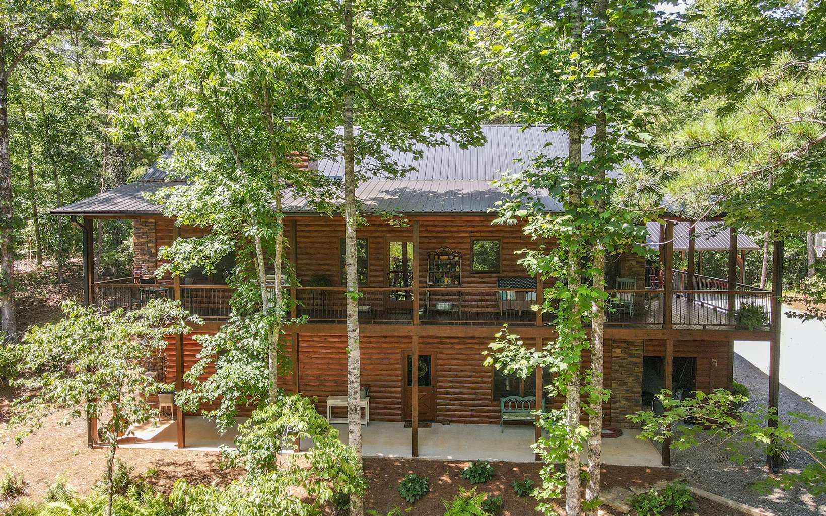Have you been dreaming of a private and peaceful life in the North Ga Mountains? This immaculate 3/3 cabin located less than 2 miles from the popular town of Blue Ridge is calling your name! A beautiful gated community that allows Toccoa River access and pavilion area for all residents to enjoy true mountain living! The highly desired Master and Laundry on the main floor plan flows beautifully and is a nice open concept while also providing a separate dining area. You will enjoy family, gaming and chilling time in the wide open basement area that also has a separate bedroom and bathroom. There is also a rare three car carport with a huge storage area above as well as a ton of storage in the cabin. Call to schedule your appointment to see this meticulously cared for, private cabin.