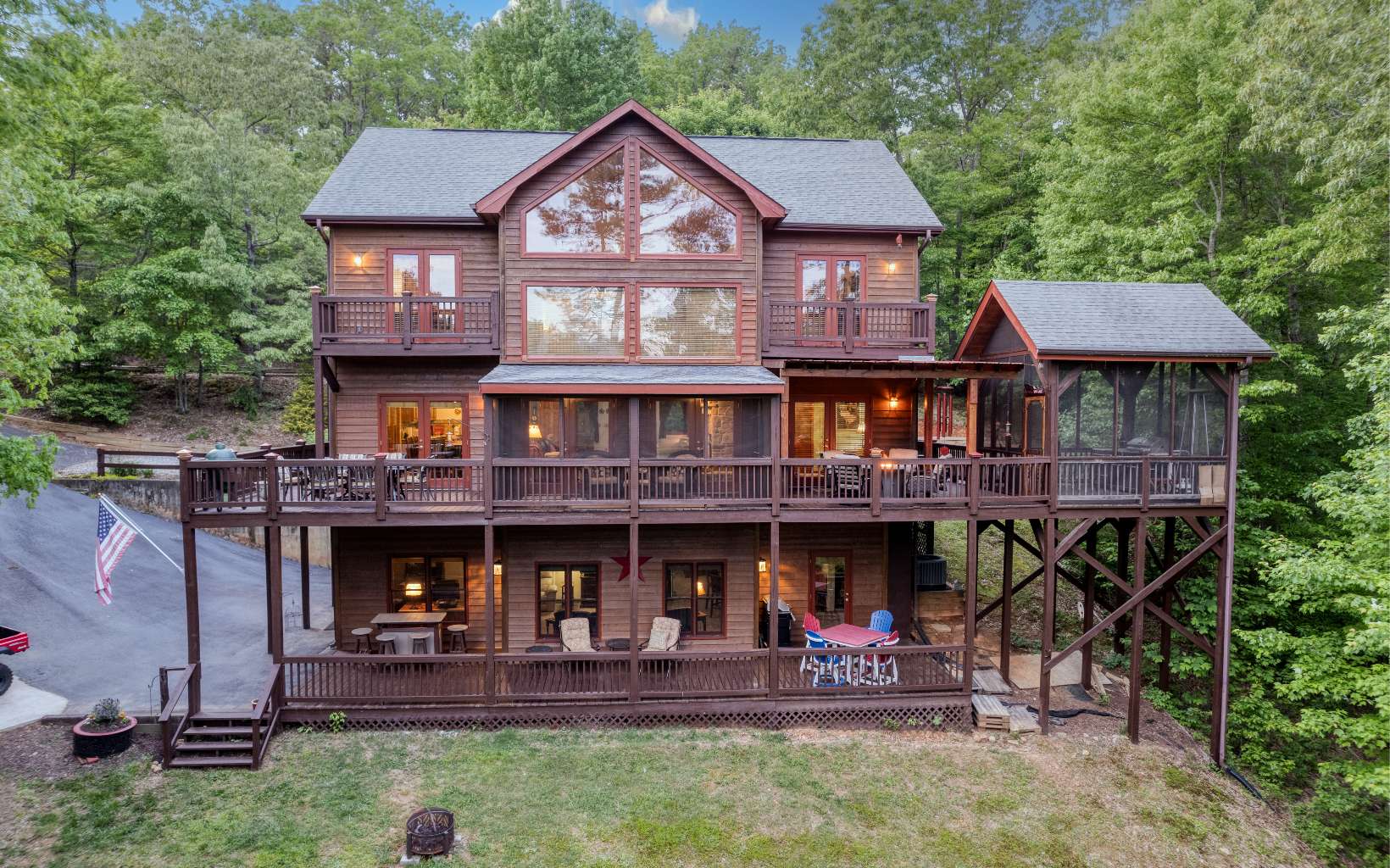 Relax in the beautiful Blue Ridge Mountains in this rustic, traditional home featuring four bedrooms and four full baths. Gorgeous views are enjoyed from soaring ceilings and oversized double pane windows in the large living room with two story stone stack fireplace. The chef’s eat-in kitchen features premium stainless- steel appliances, granite countertops, and walk-in pantry. The oversized primary bedroom suite has two walk-in closets, a private en suite with jetted tub and separate walk-in shower. Enjoy mountain views from a private balcony off the primary suite. The additional bedrooms are well portioned and have private balconies. Convenient main level laundry room. Entertaining is easy in the fully finished, walk out basement. A screened in porch and double decks provide plenty of space to enjoy the natural setting. Roast marshmallows and tell tall tales by the fire pit in the backyard. Grill and Big Green Egg for year-round grilling. Located in a quiet neighborhood with two driveways for easy access. Conveniently close to downtown Blue Ridge. YOU MUST SEE THIS HOME! There are too many upgrades to list!