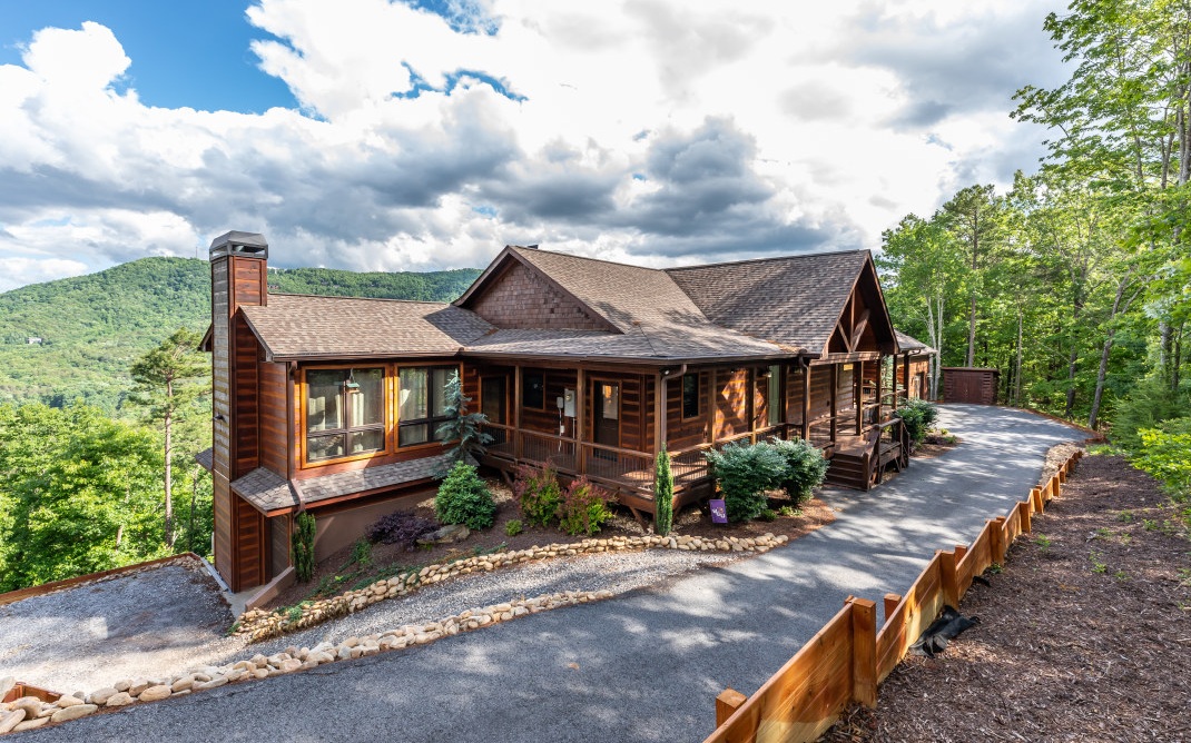 This masterpiece built in 2018 by Brown Haven Homes is your mountain forever home just waiting for you to move in! With gorgeous custom finishes, over 4,000 sq ft of living space, and amazing long-range views, this mountainside retreat is move-in ready. The great room features vaulted ceilings, huge picture windows, and access to the covered porch while the eat-in kitchen leads out onto a large sunroom. Main floor owner’s suite with vaulted ceilings, large bathroom with double vanities, soaking tub, large shower, a large walk-in closet with plenty of storage space, and private access to the covered porch for early morning coffee. Downstairs you’ll find a large den with porch access, bedroom, full bath, and bonus room. Located close to downtown Blue Ridge for convenient fine dining & shopping, and boating & fishing on Lake Blue Ridge. Come see what paradise looks like!