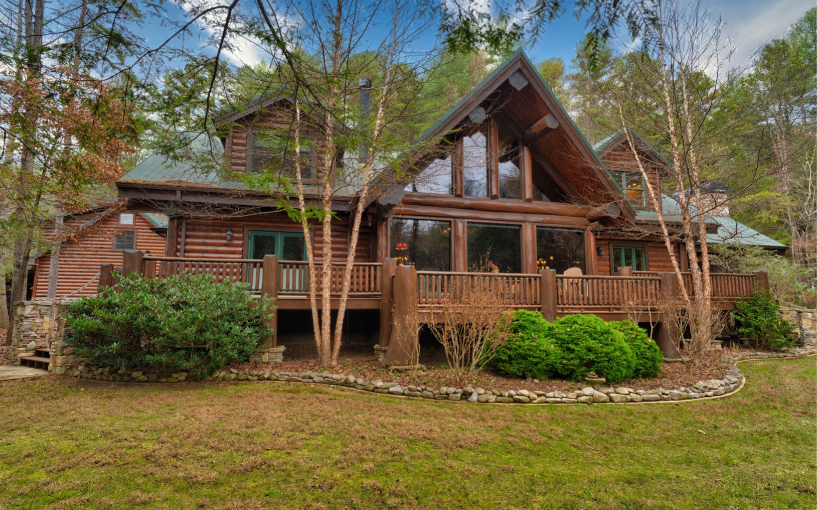 Once in a lifetime opportunity to own a large-log timber frame home with almost 300 feet of frontage in Fannin County on the sought after upper Toccoa River! Centrally located less than 35 minutes to both Blue Ridge and Blairsville. Nearly 4 acres of natural landscape and gentle entry with natural stone steps to the mild rapids of the Toccoa River. Paved road access and end of road privacy with the property bordering the national forest across the river. Expansive great room with huge windows, a tall timber frame ceiling, large stacked-stone wood-burning fireplace, a chef’s dream kitchen with an oversize island, copper sink & backsplash, double oven, warming drawer, Five-Star gas stove, custom quarter-sawn dark oak cabinetry, butler’s pantry & separate dining area. The main floor oversize master bedroom boast beautiful spa-like bath, heated floors, copper soaking tub and a large walk-in closet. There is also a home office space/guest room just off the foyer. The upper-level features 3 more bedrooms, game loft, and gorgeous bathroom. Off the kitchen is a magnificent screened-in timber frame porch with a second stacked-stone wood burning fireplace. Add in the full-length outdoor deck overlooking the Toccoa River, herb garden spot, oversize detached garage with carport and a second-floor workshop with equipment lift & two additional storage rooms for the envy of all outdoor spaces. Don't forget the backup Generac-super quiet generator. Come see this showcase custom home today.