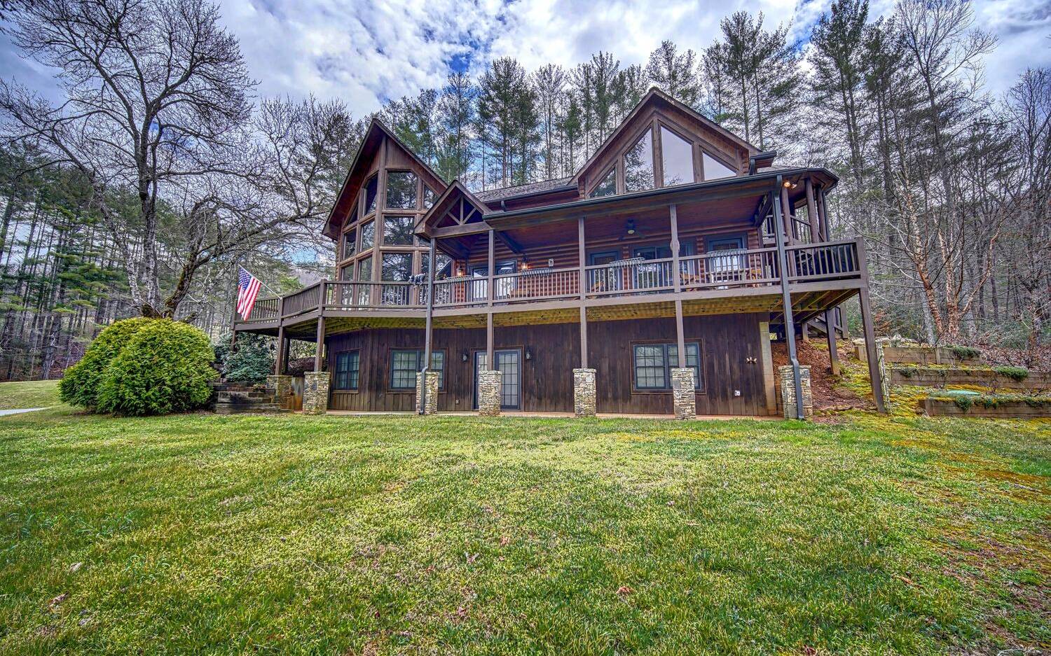 PRICE DROP!! Rustic Lodge Style Home w/ Views & Private Pond!! This 3br/2.5ba spacious home sits on 1.16ac just East of downtown Hiawassee. Open floor plan w/ prow front windows gives light the to the beautiful mountain views!! Custom kitchen w/ large island, granite counters, copper backsplash, walkin pantry, & plenty of cabinet space! Living room features gas log FP w/ stone up to T&G wood cathedral ceiling. Master BR on main floor opens to covered porch. Master BA w/ jetted tub has impressive stone work, double vanity, makeup counter, walkin shower & 2 walkin closets. Upper level features 2 roomy bedrooms, full BA, & loft area w/ custom wet bar. Unfinished BSMT is stubbed for 3rd BA & can be finished out w/ endless possibilities! Detached 2 car garage. Private pond. Wrap around deck. Side spiral staircase. Terraced gardens. Near local winery & Appalachian Trail! SHORT TERM RENTALS NOT ALLOWED.