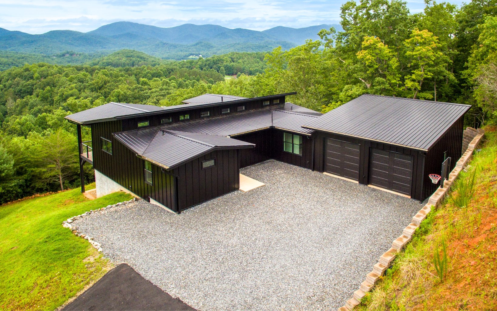 A CLASSIC MODERN HOME IN THE NORTH GEORGIA MOUNTAINS WITH PANORAMIC MOUNTAIN & VALLEY VIEWS ON 1.71 ACRES OF PRIVACY!! Patrick Construction Inc. sets the standard for energy efficient, low maintenance homes in the North GA & Western North Carolina area. This classic modern home offers an open floor plan, clean lines and sharp contrast, with approximately 1700 sf on the main floor, approximately 1500 on the lower with an attached oversized 2 car garage. It features Standing seam metal siding in all black with multiple layers of radiant protection beneath. Spray foam insulated with Marvin Integrity windows and doors, inset custom cabinets, high quality fixtures throughout. Stainless cable railings, IPE decking, zero entry shower, custom shelving and built ins. The main level features a great room with lots of glass to enjoy the views, 2 bedrooms/2 bathrooms, kitchen, laundry room and expansive covered & open air deck. The lower level features 2 additional bedrooms & 1 bathroom, a living room and storage room.