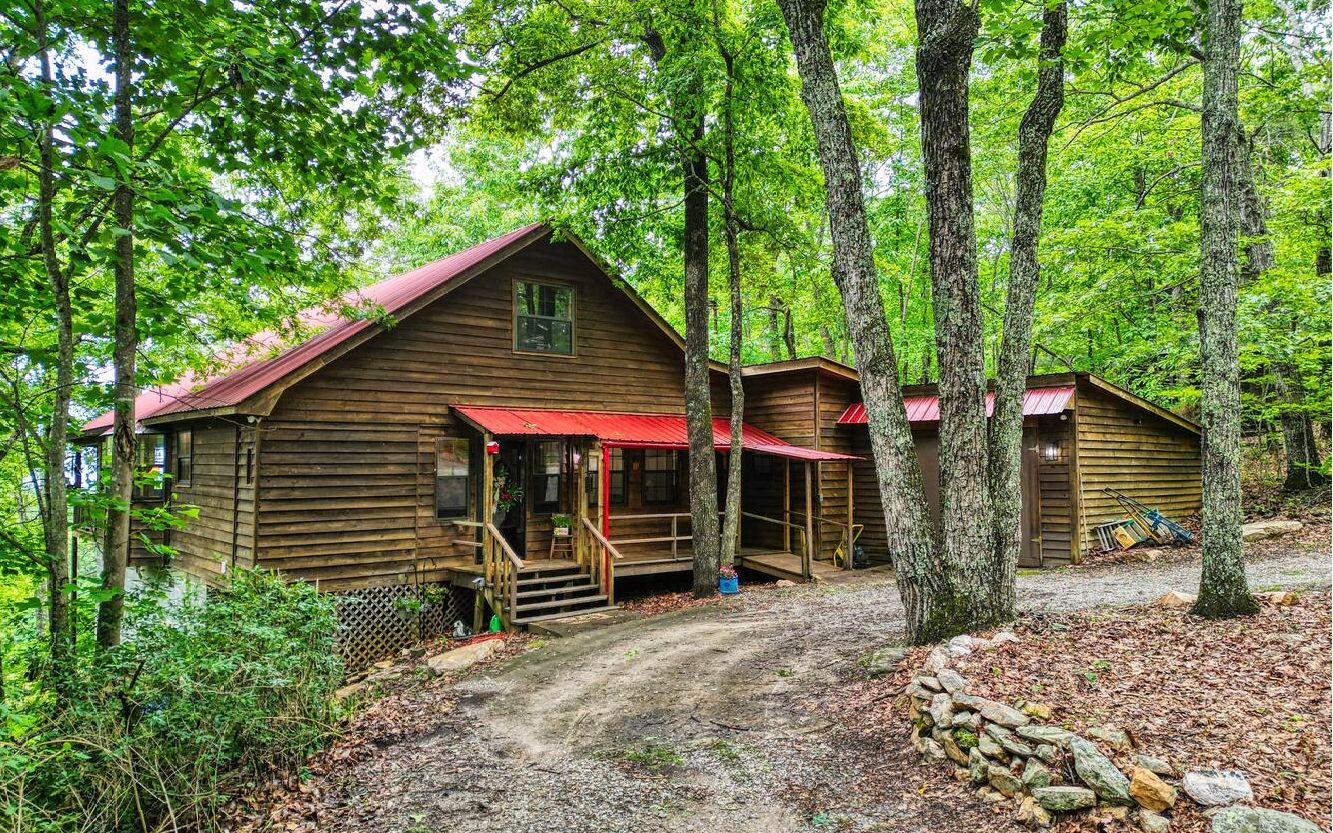 OPEN HOUSE 6/10 & 6/11 from 1-4PM! Adorable, rustic cabin located "away from it all" on 4.98 acres and yet only 15 minutes into town! So very private, with USFS bordering front of property and a "one in a million" long range view from the large, covered deck of Big Frog Mountain (TN) and the NC mountains. Pasture view as well, and She-Shed and dog/chicken pens for your fur and feather babies. Den/office with kitchenette and enclosed screen porch.
