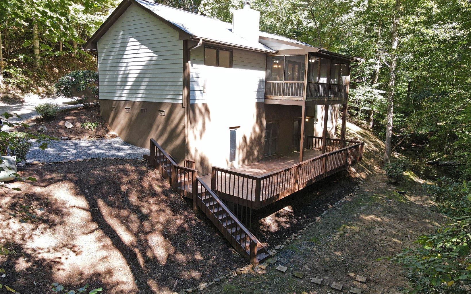 "Can't Build this Close to the Creek Anymore!" Newly Renovated Creek-Front Cottage! 2 Bedroom, 2.5 Baths + Additional Bunk Room and Full Finished Basement for Additional Living Space + HUGE Party Deck Overlooking the Creek & Wooded Setting. The Perfect Space to Entertain your Family & Friends! One Level Living with 2 Beds, 2 Baths on the Main Floor + Laundry Room. Granite in the Kitchen, Vaulted Ceilings with Wood Beams and 'Rocked' Wood Burning Fireplace in the Great Room with Access to the Screened Porch to Enjoy your Morning Coffee! Lots of Potential with this Unrestricted Lot. Don't worry about Living so close to the Creek, it is NOT in a Flood Plain. Fabulous Location: Close to Crane Creek Vineyards, Young Harris College, Brasstown Valley Resort & Spa for Dinner, Drinks, 18 Hole Championship Golf Course & a Relaxing Day at EQuani Spa!
