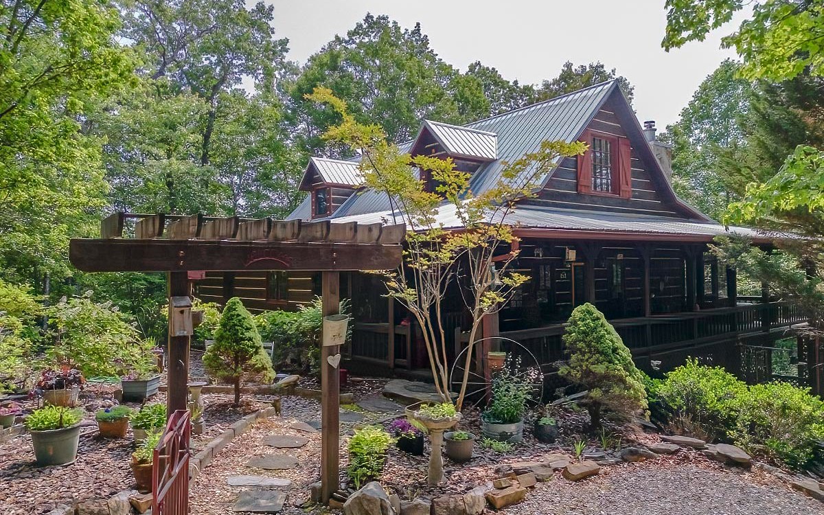 It is rare to find 8.81 acres within the Mountain Tops Subdivision and this close to the city of Blue Ridge. This quintessential rustic true log cabin has 3 bedrooms, and 3 full bathrooms, with an oversized master suite on the main level. Upgraded stainless steel appliances in the kitchen including Thermador Professional cooktop & double ovens and walk-in pantry. Large covered back deck with great mountain view potential. All paved roads, including a concrete driveway, lead you to this property. The living space on the terrace level is a great mother-law space, Airbnb or studio apartment, with brand new full kitchen and guest quarters. Additional noteworthy features; clawfoot tub, central vac system, basement garage, wood stove, and newer metal roof & HVAC system.