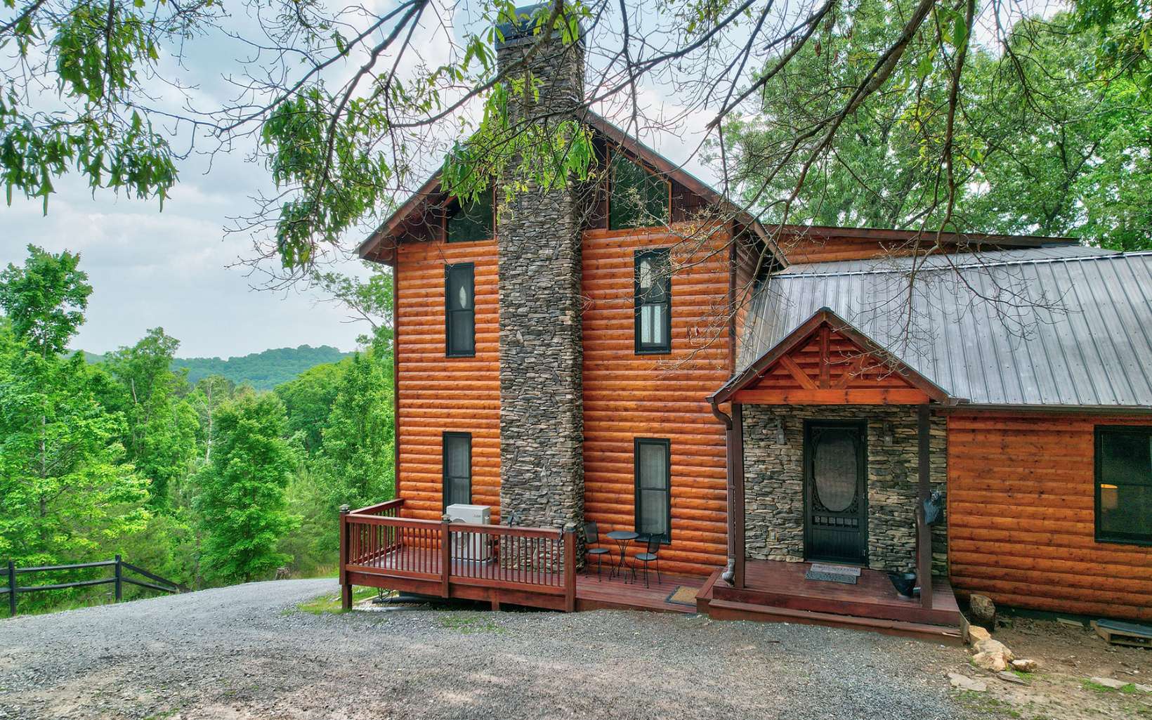 Retreat from the noise and distraction of city life to your tranquil cabin in the North GA mountains where there is plenty of room to roam. This property has 8.4 diverse acres, some wooded for seclusion and some pasture with a small creek and chicken coop, perfect for a few farm animals. This home has 3 bedrooms plus a small sleeping loft perfect for the kiddos, and a finished workshop or extra sleeping space with half bath in the basement. The upstairs master suite is vast with a cedar walk in closet and private covered porch with a peekaboo long range view of the mountains. There is a game room space as well on the main level complete with a shuffleboard table for endless entertainment. This home is sold furnished and would make an excellent STR/vacation rental. Just a 4 minute drive to Horseshoe Bend Park at the Toccoa River for kayaking, fly fishing and tubing and a 20 minute drive to downtown Blue Ridge.