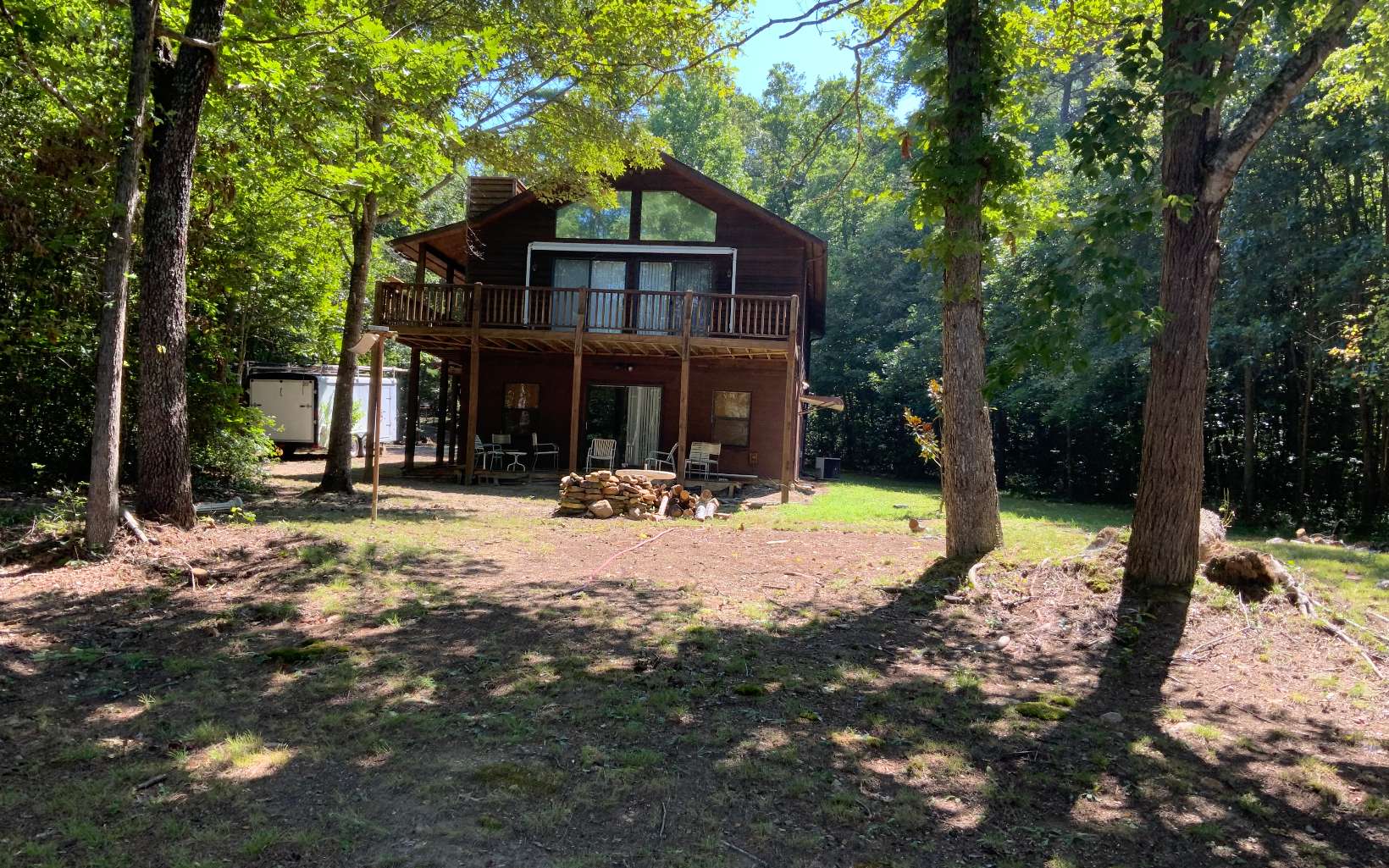 Rare opportunity to own one and a half acres on Lake Nottely with lake access. Current house is a three bedroom, two bathroom home, with unfinished basement, separate two car garage and additional storage shed. Great space to expand or build new.