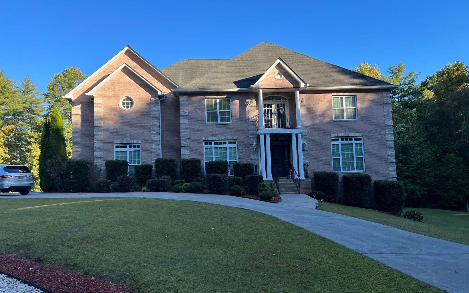 This is a custom built home. It is a three sided brick home that is three levels which includes the basement level. Very spacious and open. It is a pink brick color. It has two sets of stairs. Has a curved entrance stair. Has granite countertops. Has a guest room with a bathroom on the first floor. It is a three car garage. It has a sunroom and a recreational room. The basement is totally finished out. It also includes a second kitchen.