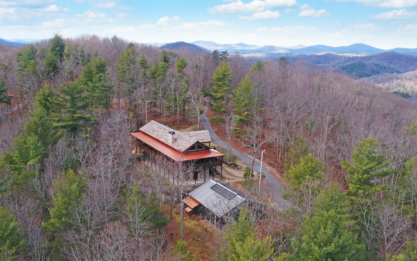 Custom Log Lodge on 3,000 ft elevation North GA Mountain top, 3 acres and 17 additional acres adjoining National Forest available with fantastic views! Spectacular potential wedding/event venue! Main house features 30' wood ceilings w/Massive stone masonry fireplace,chef's kitchen & huge great room with windows and doors opening to a wrap around porch to enjoy jaw dropping mountain views,4 Bedrooms with en-suite spa baths with flagstone floors in baths and custom tile work.All Bedrooms open to covered porches with views!Full finished terrace level incudes separate living & kitchen & bar,stone FP,wine cellar,walk outside to enjoy enclosed glass house with large heated wave pool!Extra Guest Log house available for purchase features 2BR,2Bath,masonry stone FP,large porches with great views!Stone gated entrance with long paved private drive,terrace gardens,babbling waterfall feature.Propane backup generators.Terrace garden areas,fenced area for your farm animals. Too many extras to list!