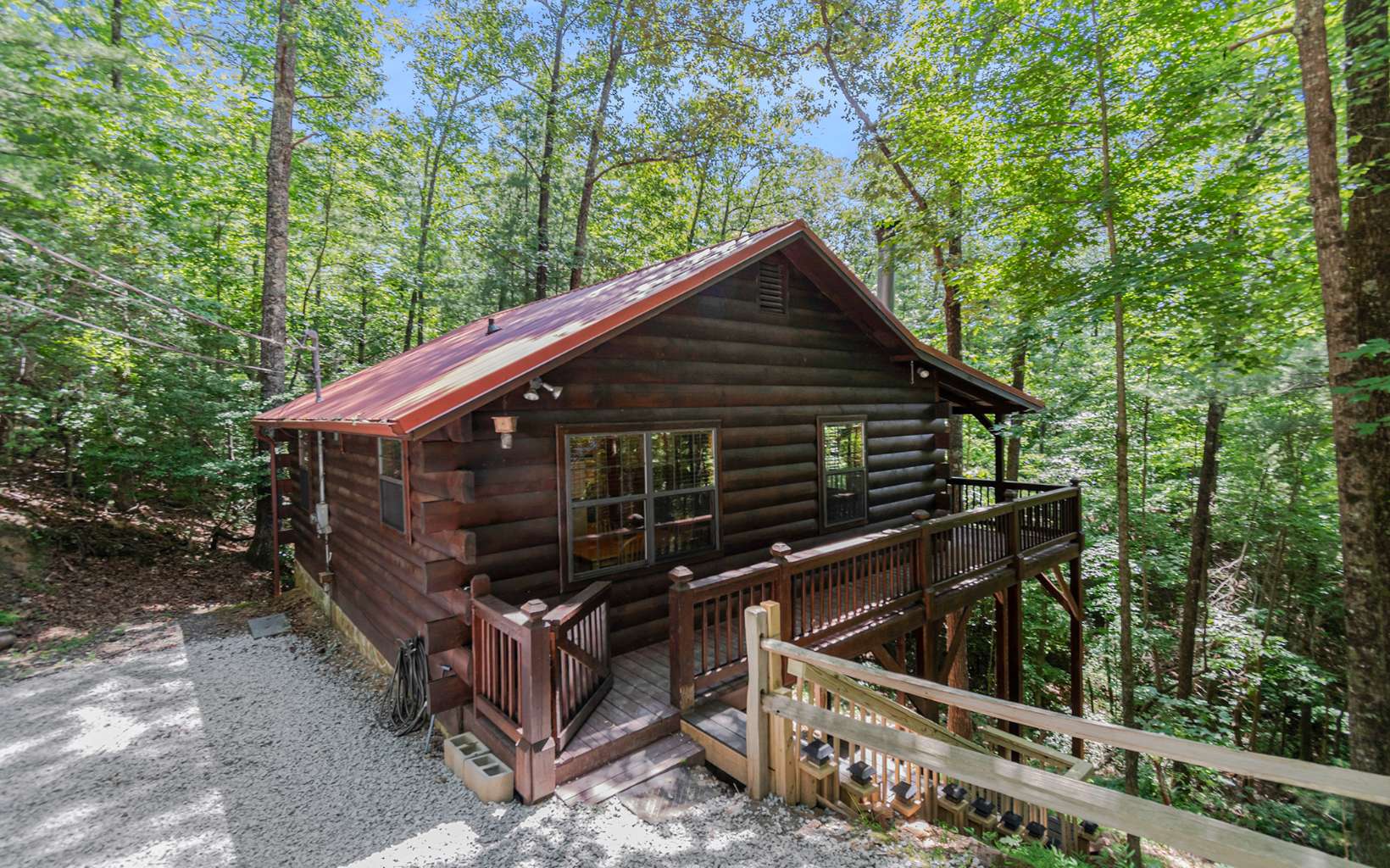 Perfectly situated between Downtown Blue Ridge and Ellijay GA, this SHORT TERM RENTAL ready cabin is waiting for you! A true sought after Sisson Log cabin offering 2 bedrooms and 1 full bath that is FULLY FURNISHED! Rental experts have given rental projections of nearly $50,000 a year with 230 nights expected to be rented. Open floor plan with wood burning rock fireplace. Brand new roof and gravel on the driveway. Covered deck across the back of the cabin to enjoy the nature that surrounds you. Plenty of storage space in the stand up crawl space. Nearby North Georgia amenities include wineries, hiking, mountain biking, fishing, and more! It is being sold furnished and is ready to go!