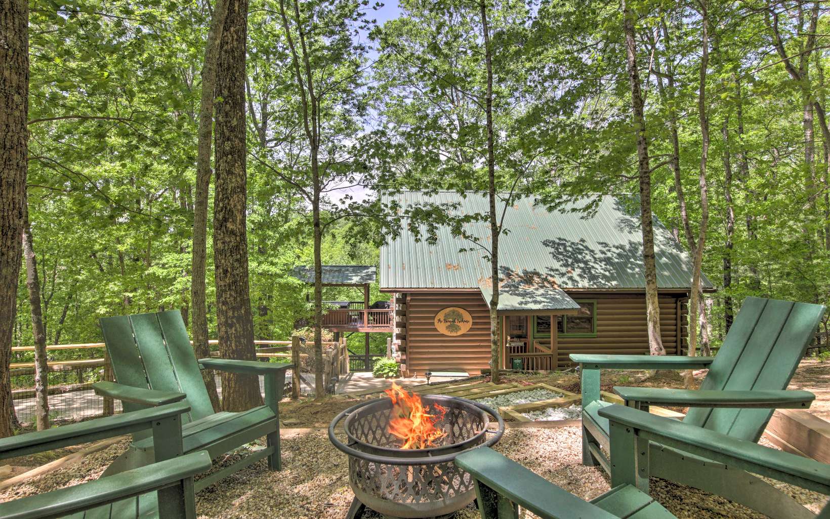 Picture-perfect fairytale cabin, nestled into the woods with end-of-the-road privacy and gorgeous sunset views. Just 5 miles to Downtown Blue Ridge! This is exactly what you want in a mountain cabin retreat...and then some! Perched on a ridge and surrounded by the lush Chattahoochee National Forest, you truly feel like you are living in a treehouse here. The cabin is located in the enchanting Cherry Lake community of Cherry Log, Ga. (between Blue Ridge and Ellijay) From the moment you enter the neighborhood, you will be transported into a magical and serene mountain paradise, surrounded by lush forest, tranquil streams, and abundant wildlife. The famous Benton MacKaye trail runs through the neighborhood...you can literally hike right out the front door of our cabin. Other features include numerous lakes and streams, stunning mountain views and an adorable lakeside.