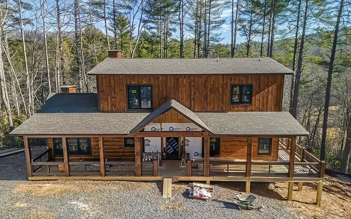 This is a perfect opportunity to be a part of a NEW build in Morganton, GA! The unique charms of your new modern, rustic cabin will leave you speechless. Perfectly poised on a wooded, mtn. view lot of 2.00 acres with paved road access to driveway. Open floor plan combines kitchen, dining area, & living room with vaulted ceilings & real stacked stone FP, Or open the doors leading to the porch to become a spacious living area with outdoor FP. Details include light/dark wood, granite countertops, & unique light fixtures. Loft area suited for the kiddos! Master suite on main or upper level - entrance to deck, double vanities, separate tub, & stone shower. Private entrance to terrace level with FP, wet bar, & 1BR/BA for guests. Conveniently located between Lake Blue Ridge & Lake Nottely. PHOTOS are representative of finished home, Exterior construction, colors, & finishes subject to change.