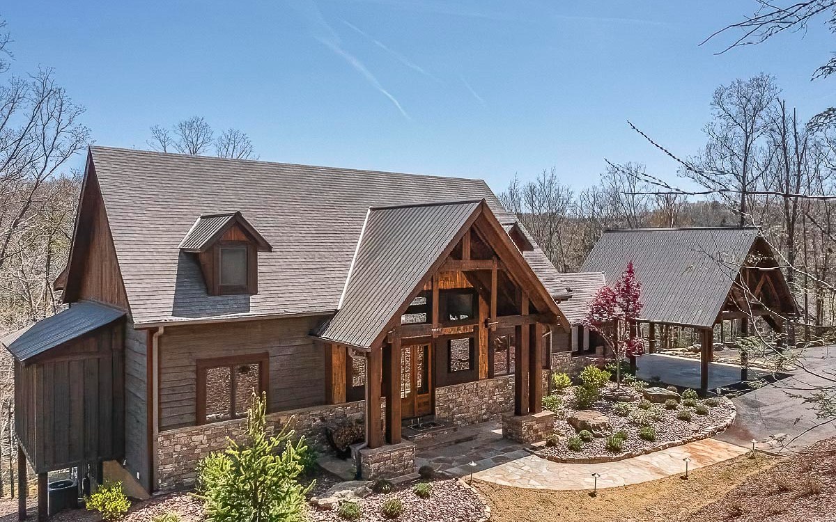 Stand back & take notice of this Stunning modern-rustic Craftsman-style home Built by Keith Sumner Homes offering his unique design & finishes with the opportunity to be a part of the sought-after Street of Dreams Community surrounded by the rushing waters of Fightingtown Creek. The majestic home sits just above the Glistening Trout Stream w/211 ft of waterfront beauty & a widespread backyard of natural surroundings, rock bolder landscaping & Timber Frame Creekfront Pavilion w/stone flooring & massive, stacked stone FP. Add’l features of the 4BR-4BA Custom Home include, expansive Wood-Aluminum Clad windows & 4 Panel Slider doors where inside merges w/the beauty of nature outside; soaring rough sewn wood ceilings; custom barn doors, distressed wood flooring, 3 master ensuites w/custom rock showers, waterfall shower & soaking tub in master, 3 exquisite stacked stone FPs, 2 interior & 1 exterior on covered party porch overlooking the creek, Viking Appliances, granite countertops on main & unique concrete BA countertops on terrace level plus a rustic crafted wet bar; full terrace level porch, whole house generator, paved DW & 2 car Timber Framed Carport! All this perfect creekfront luxury awaits you!