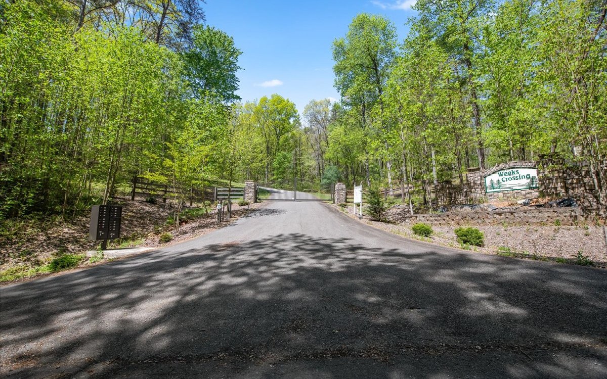 Move to the Mountains!!!! This beautiful seasonal MOUNTAIN VIEW 2.08 acre lot in Weeks Crossing is just for you! Just minutes from beautiful downtown Ellijay. This small gated community has all paved roads, fiber optic internet, underground utilities, mature hardwoods and a great location ready to build your dream home on. Bring your builder so you can get started living your best life. Ellijay is the APPLE CAPITAL and MOUNTAIN BIKE CAPITAL of GEORGIA.