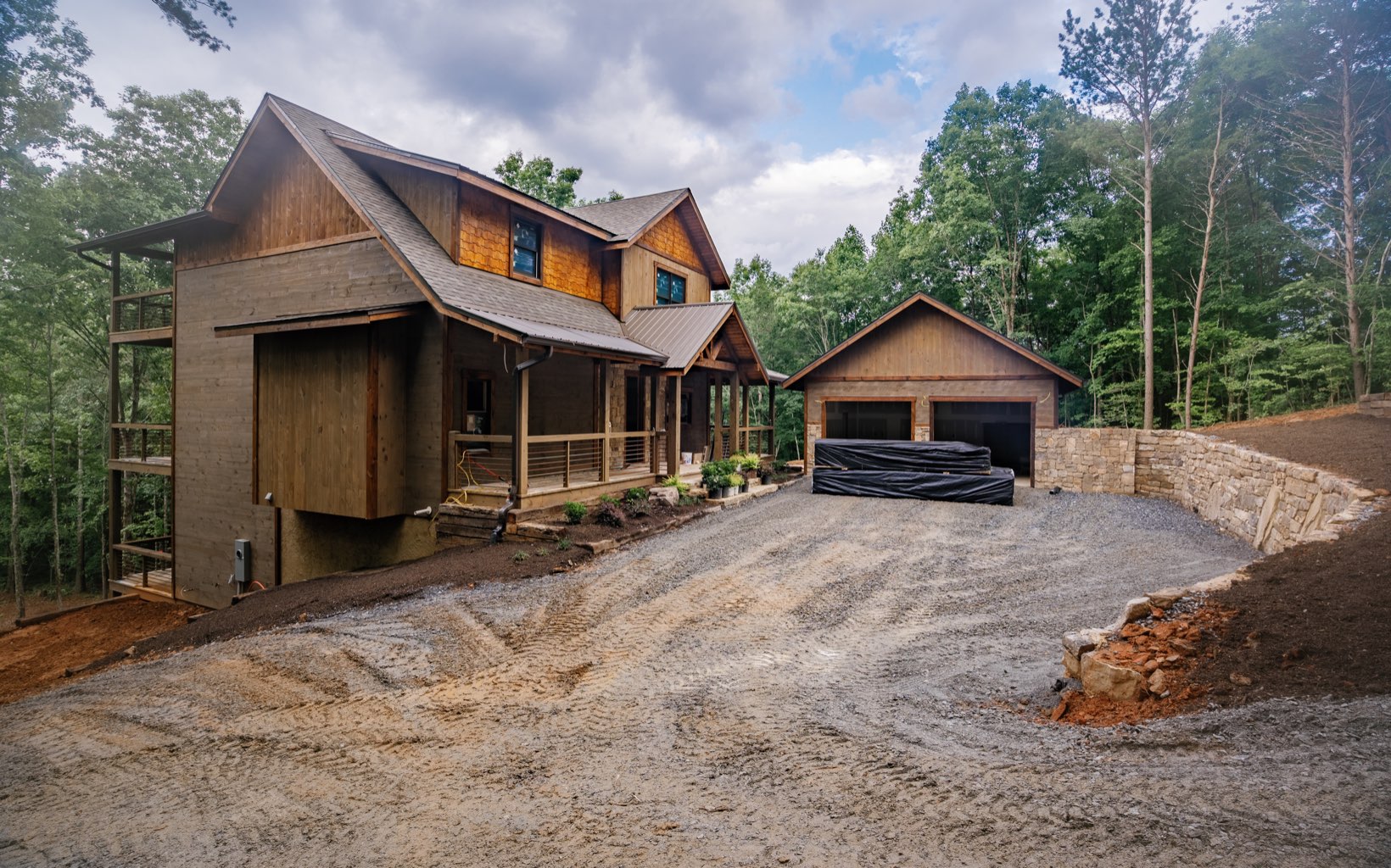 Enjoy the luxuries of modern rustic living in this stunning new construction creation by Lomonaco Log Homes! Welcome to "Creekside," a home w/ a blend of modern and rustic finishes and three levels of outdoor decks overlooking a beautiful backyard and steps down to the noisy & wide creek. Inside, home is complete w/ three full ensuites, two additional half bathrooms, and a large sleeping loft or fourth bedroom! Beautiful hardwood floors, stacked stone F/P's, S/S appliances, walk-in tile showers, and cathedral ceilings adorn the retreat w/ warmth and textures. Large sliding glass doors let the outdoors in throughout the entertaining spaces. Terrace level den is complimented w/ a wet bar, living and gaming space. With boulder walls, beautiful landscaping, and LARGE two car garage, this home won't last long.
